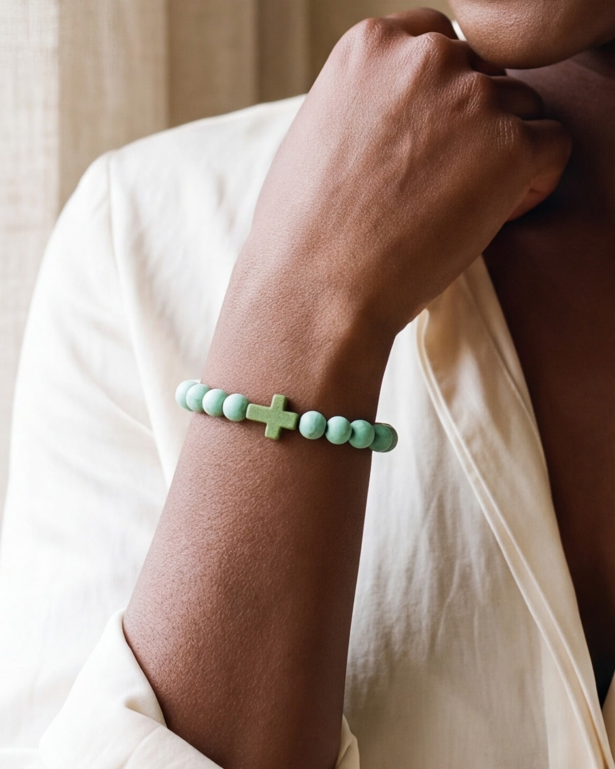 The Beaded Cross green stone bracelet on a woman's wrist, close-up, true to size [c:green]