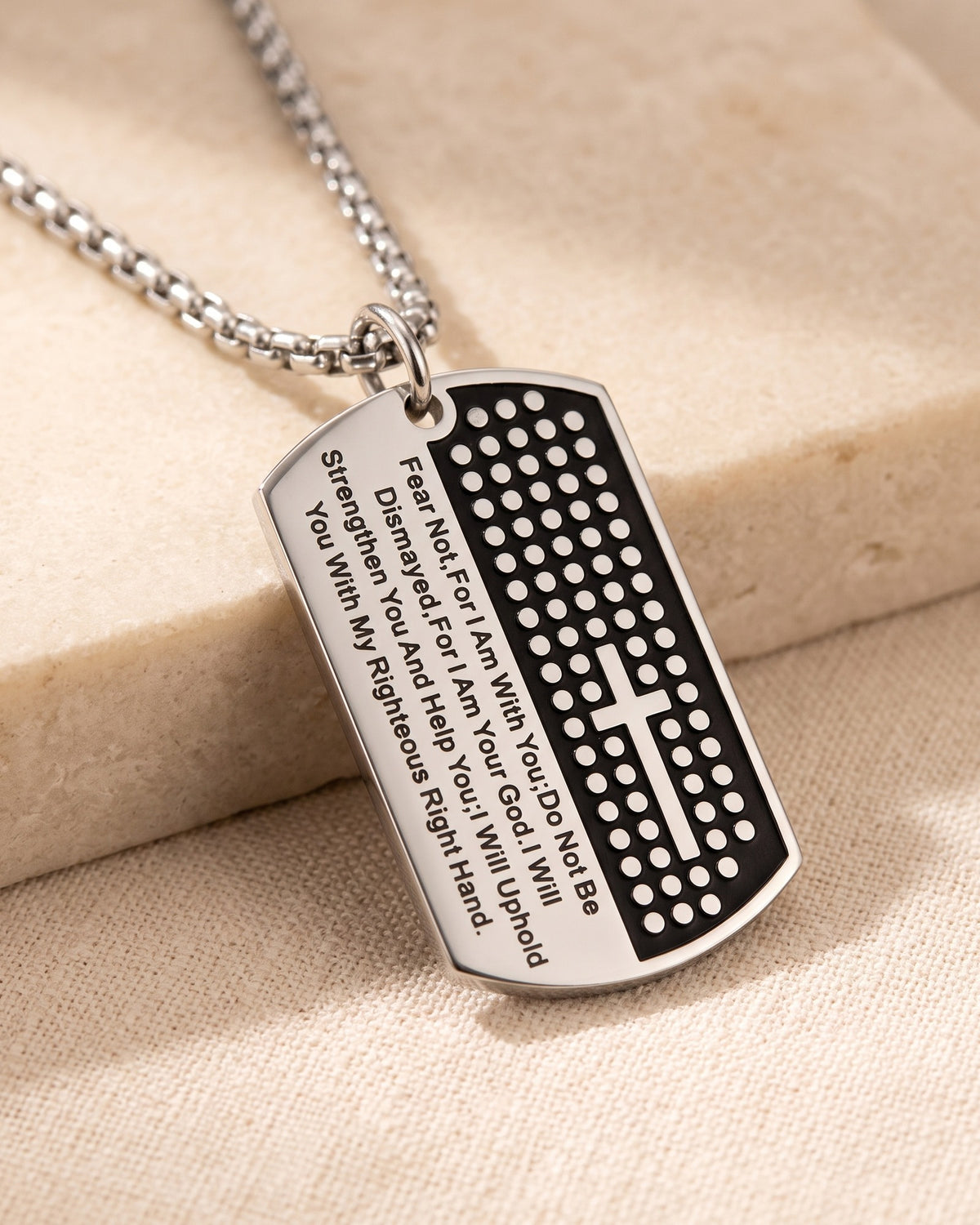 Close-up of The Steadfast Word dog tag, Isaiah 41:10 engraving, three-quarter view [c:silver]