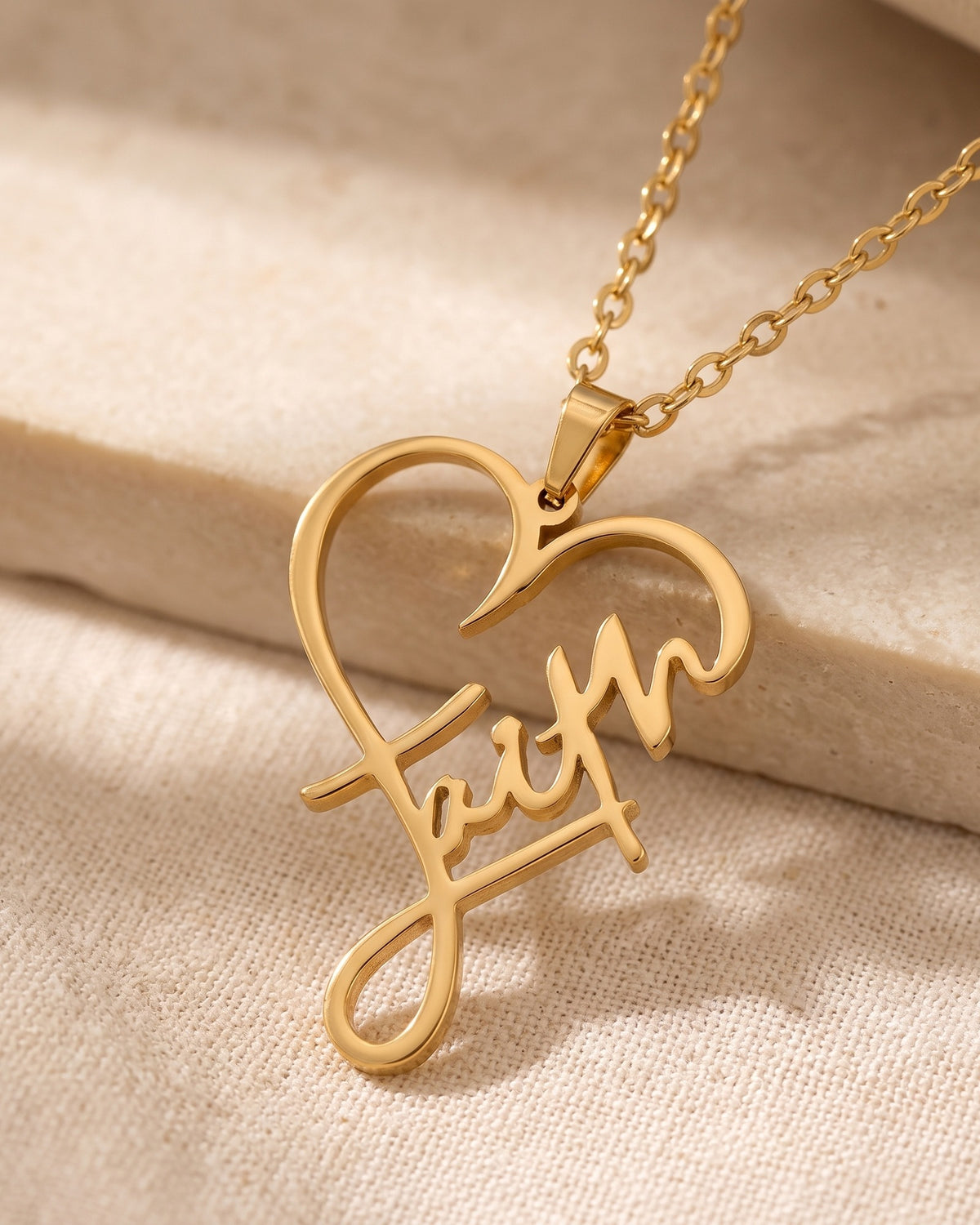 Close-up of the gold Faithful Script necklace, three-quarter view [c:gold]