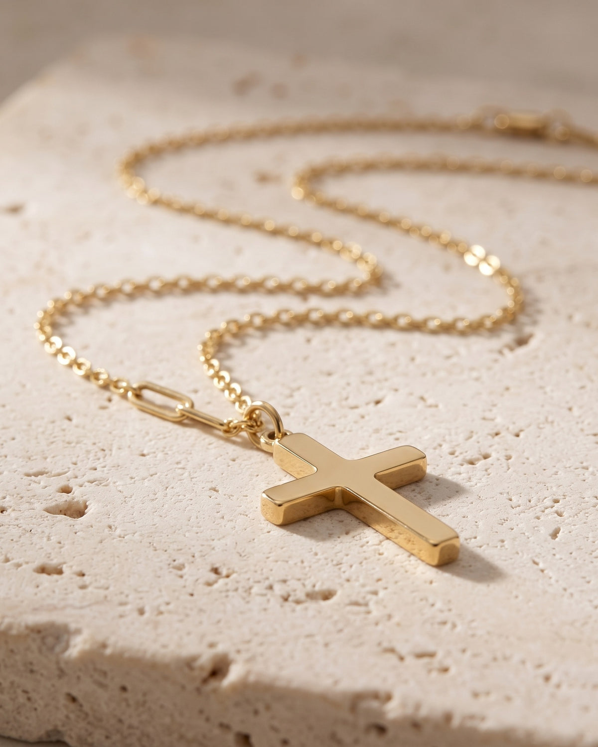 The gold Godchild's Cross, side view on stone [c:gold]