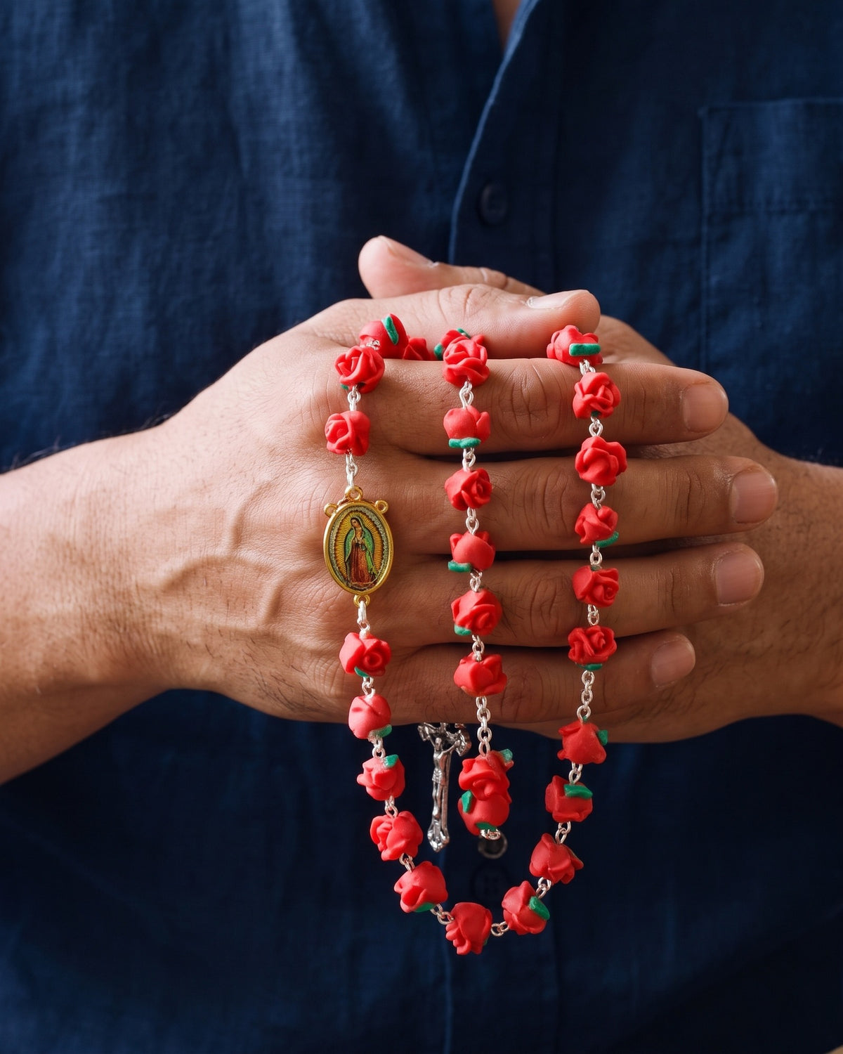 The Guadalupe Roses held in a man's hands, close-up, true to size