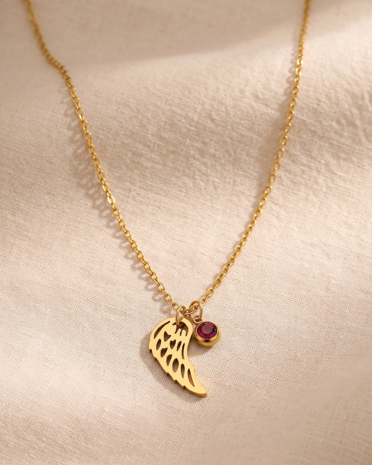 The whole Angelic Birthstone necklace on linen, true to scale with its fine chain [c:january]