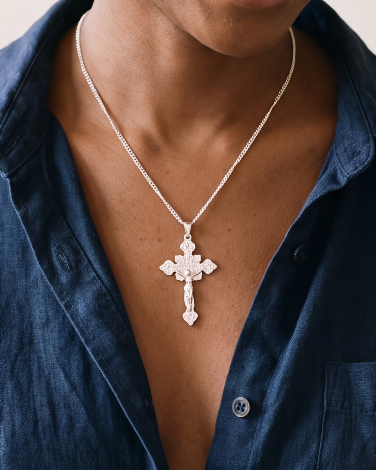 The Calvary Crucifix worn by a woman, close-up from chin to chest, true to size [c:silver]