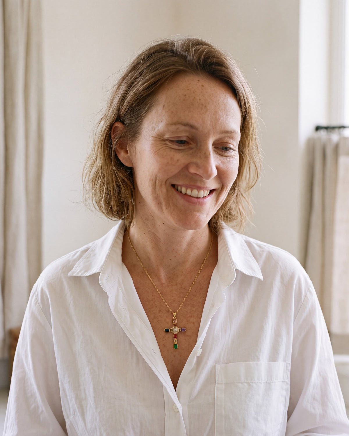 The Adorned Cross worn by a smiling woman