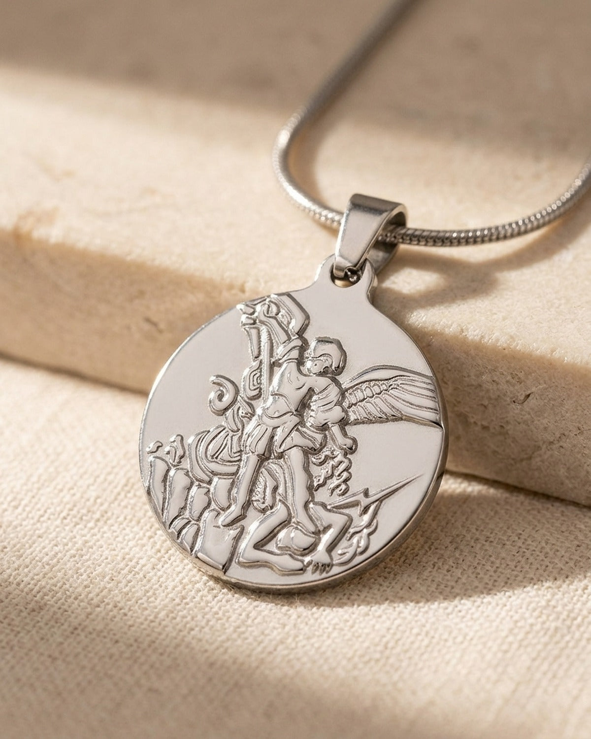 The Angelic Protector medal held in the hand, true to size [c:silver]
