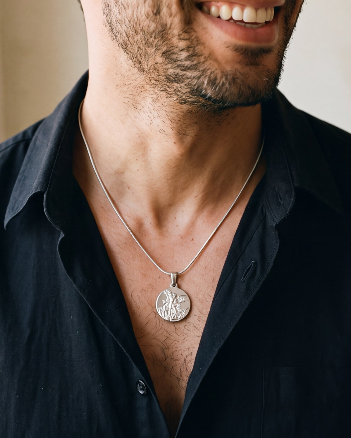The Angelic Protector medal worn by a man, second close-up, true to size [c:silver]
