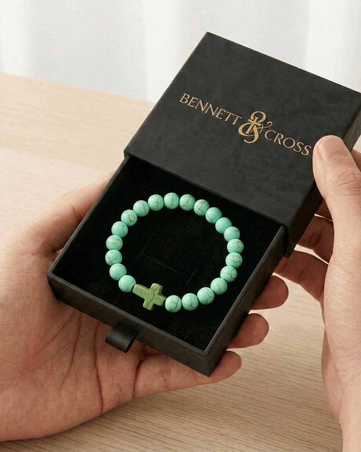 The Beaded Cross bracelet in its Bennett & Cross gift box [c:green]