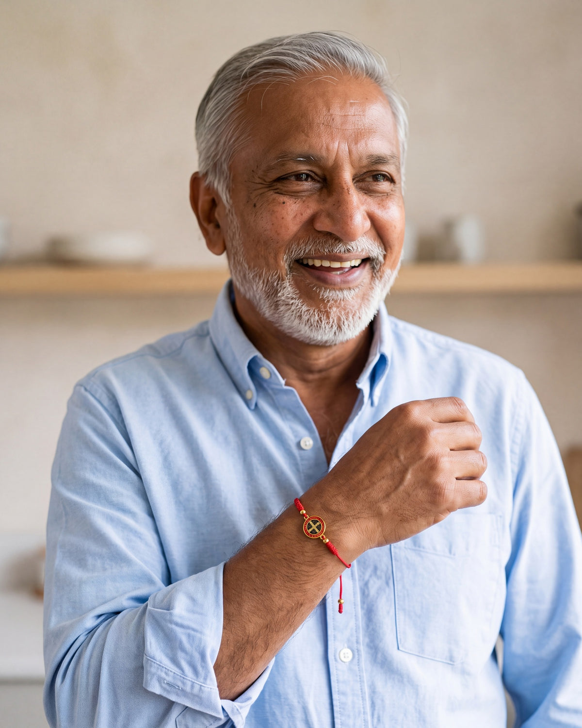 Smiling man wearing the Benedict Red Cord