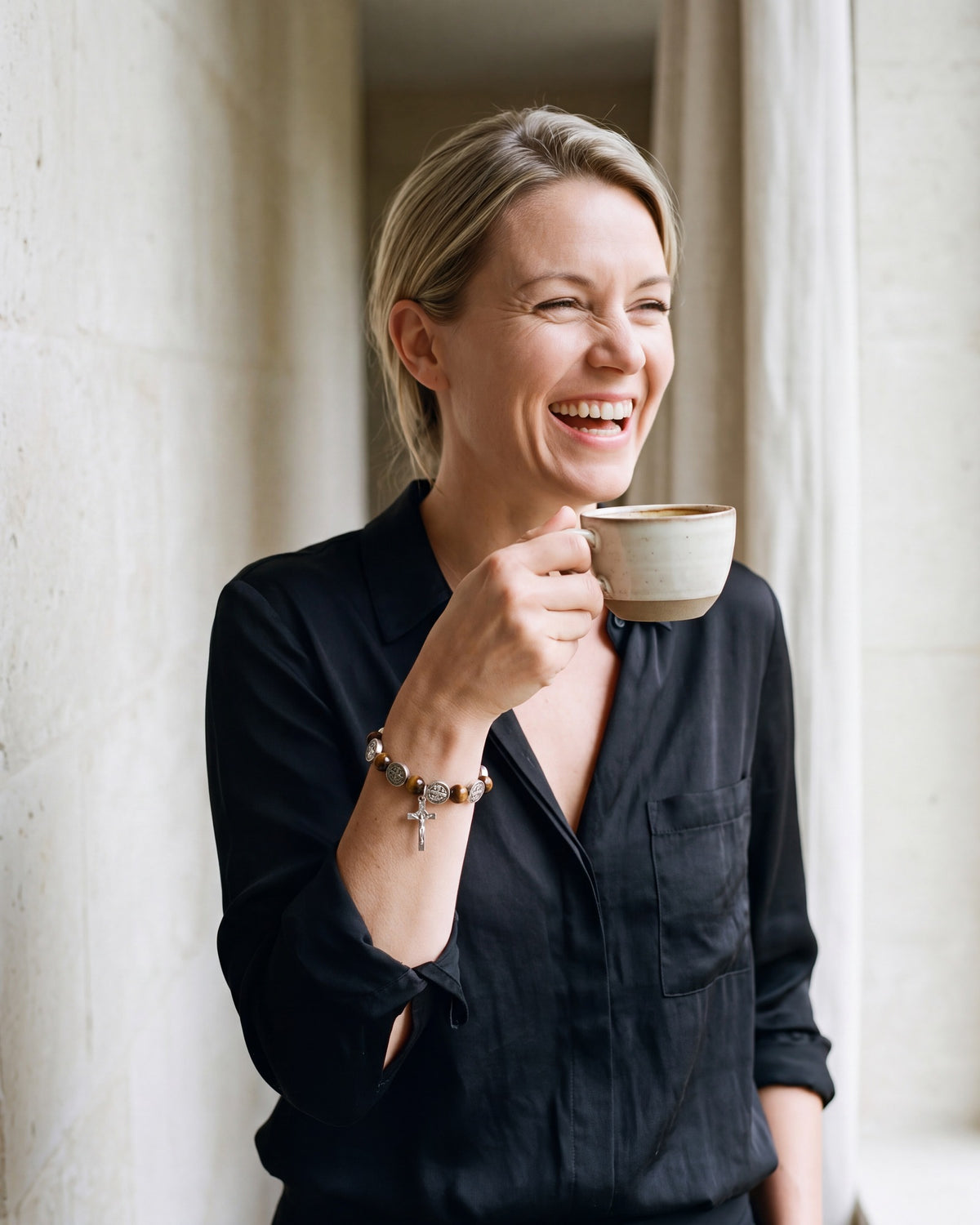 Smiling woman wearing The Benedict Tiger's Eye bracelet