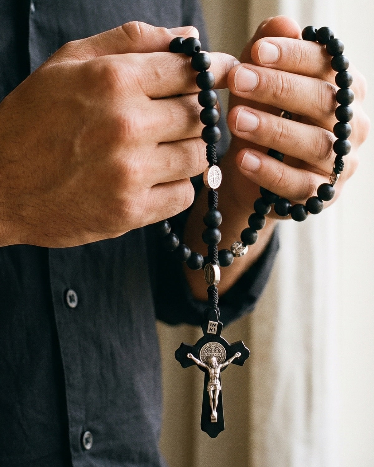 The Benedictine Path held in a man's hands, close-up