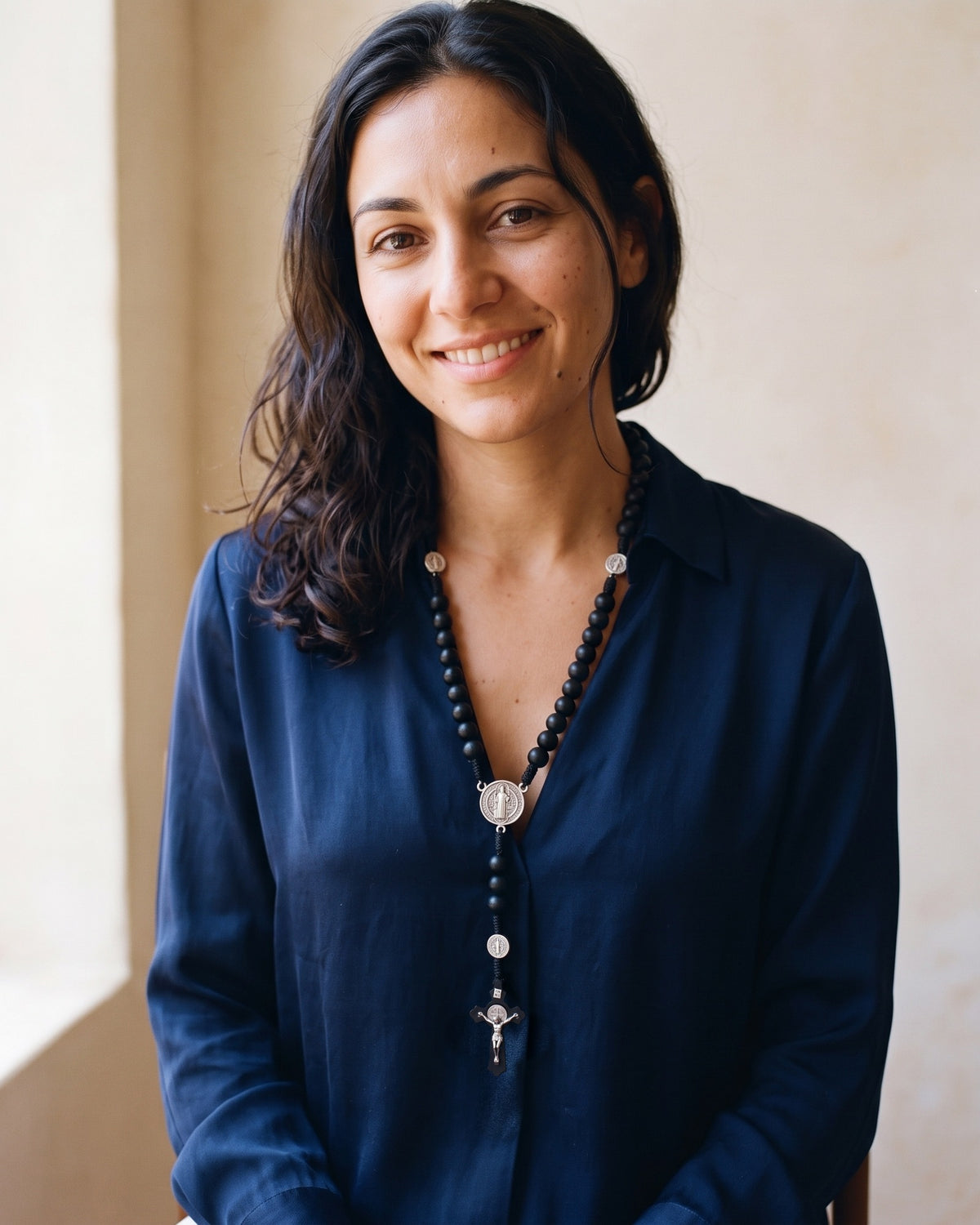 Smiling woman wearing The Benedictine Path rosary around her neck
