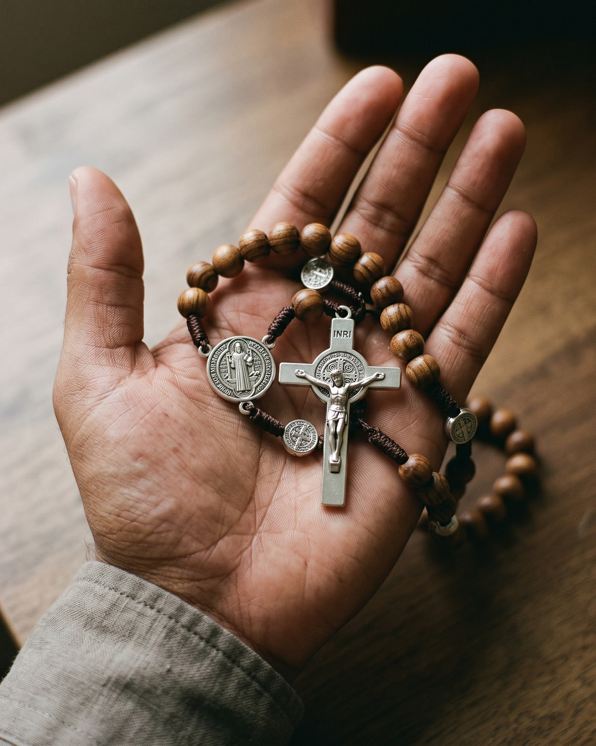 The Benedictine Rosary crucifix in the palm of a hand, true to size