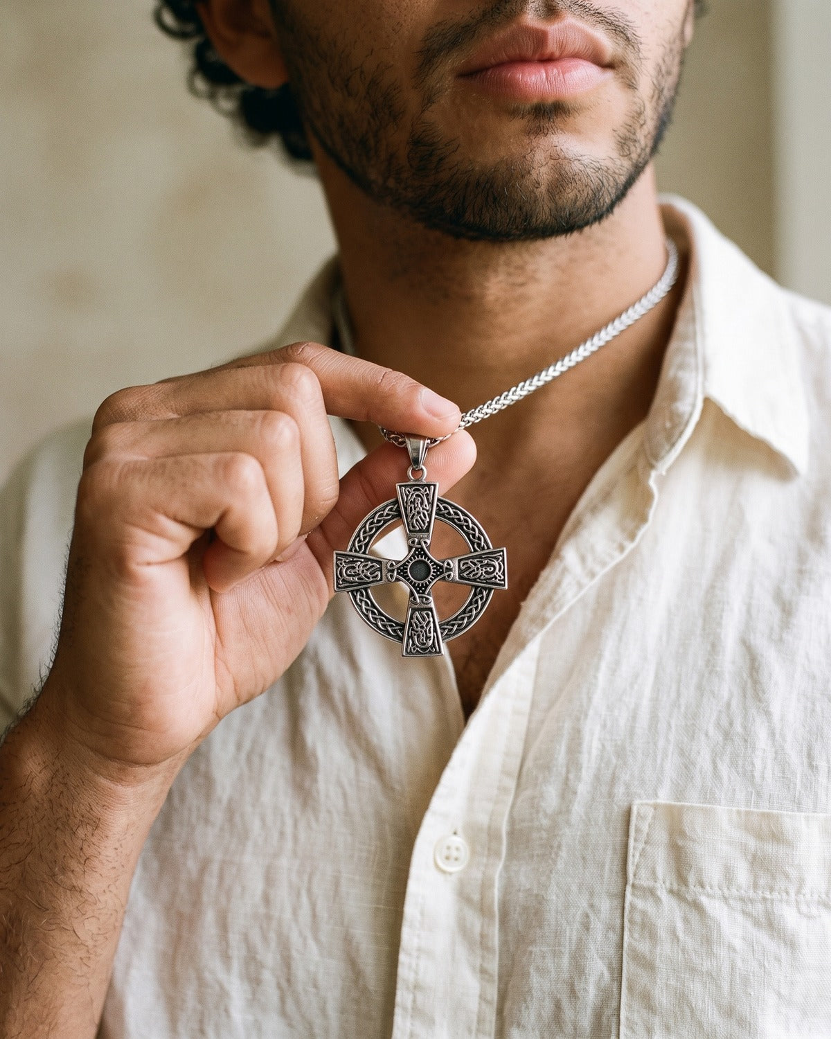 The Boundless Knot held between the fingers, true to size [c:antique-silver]