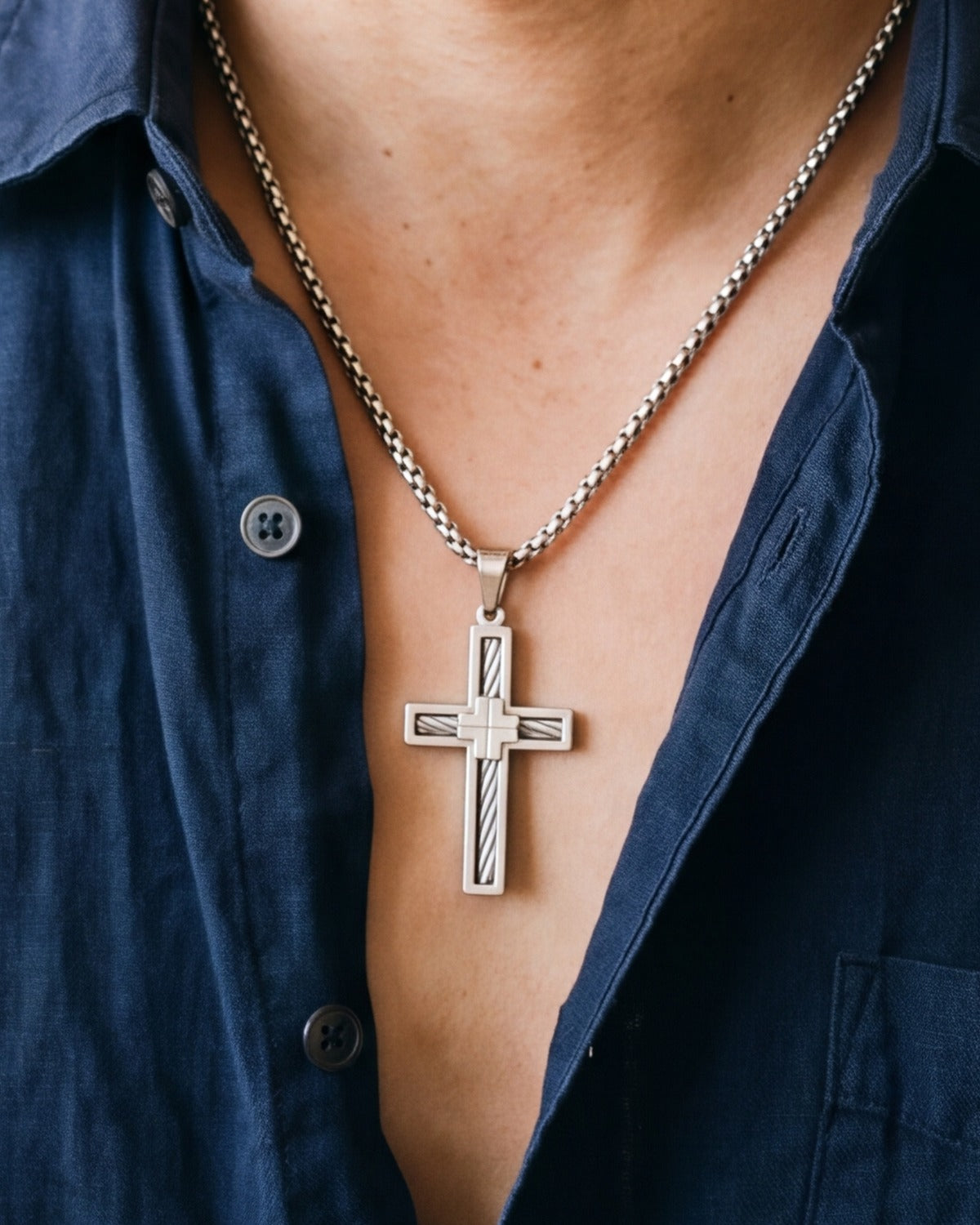 The Cable Cross worn by a man, close-up, true to size [c:silver]