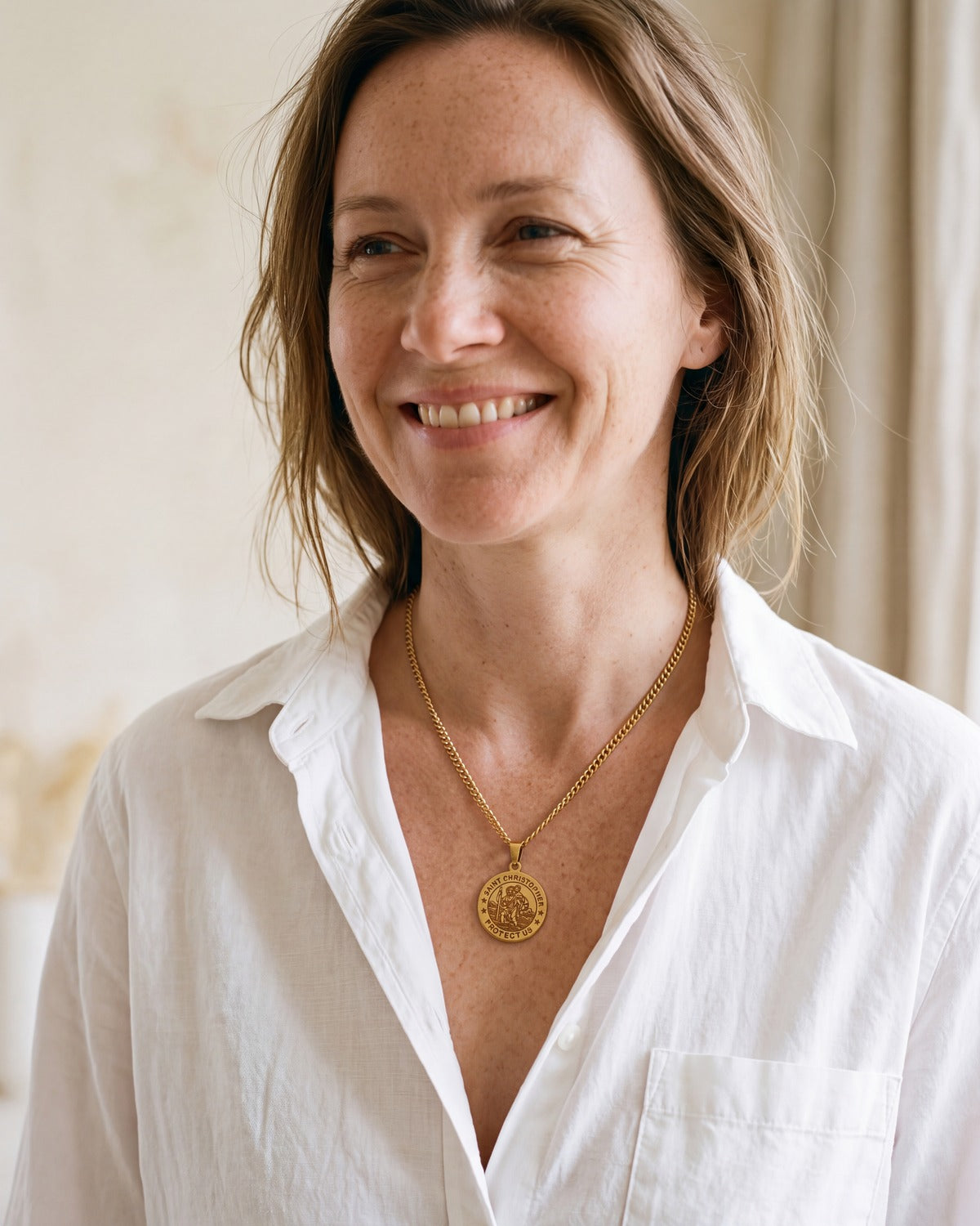 Smiling woman wearing The Christopher Coin medal [c:gold]