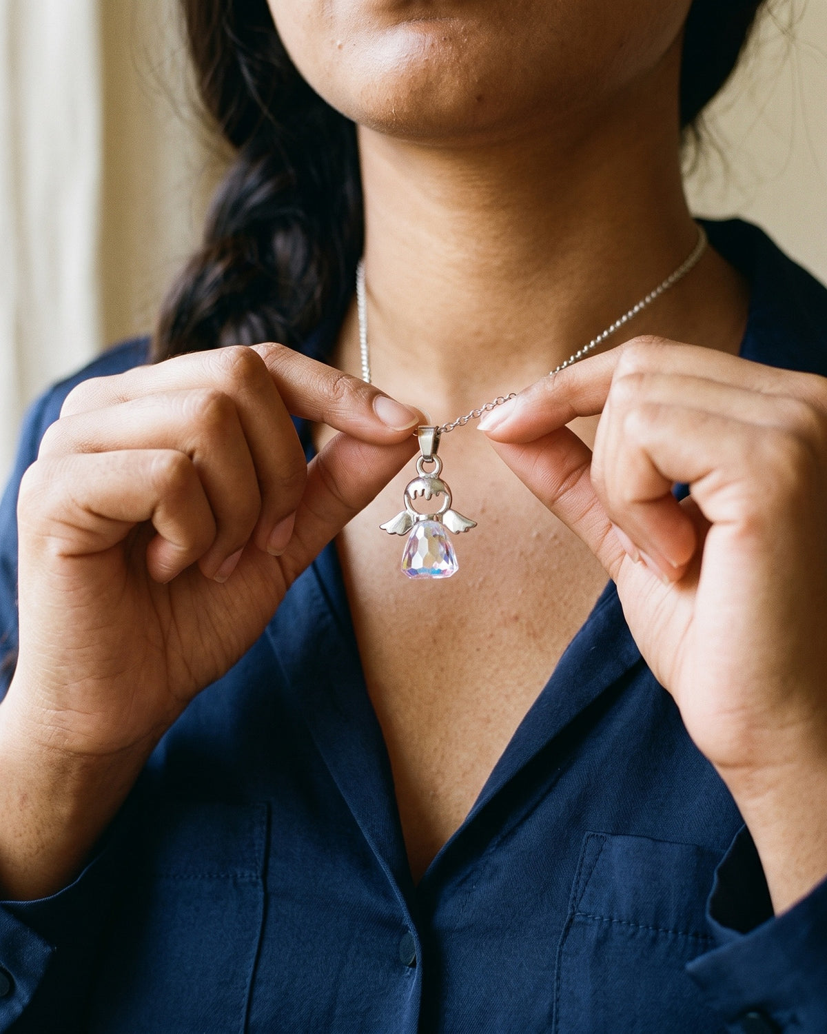 Woman holding The Crystal Guardian between the fingers