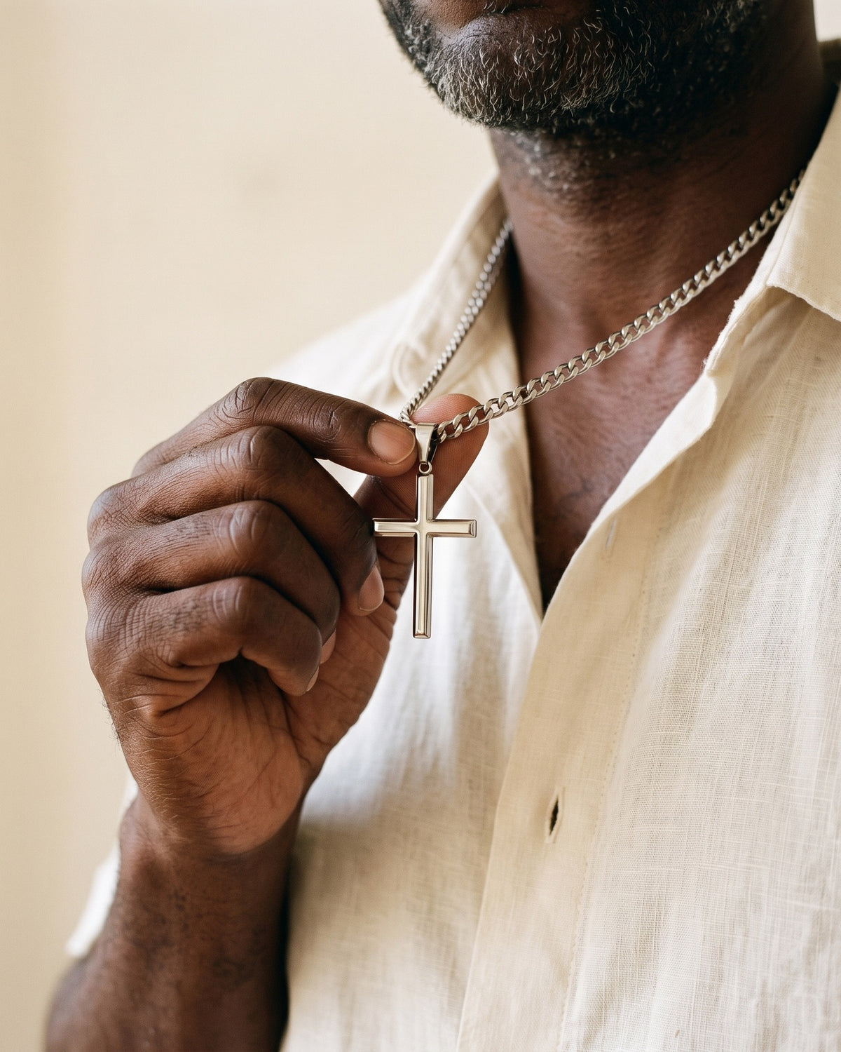 Man holding The Devotional Cross between the fingers [c:silver]