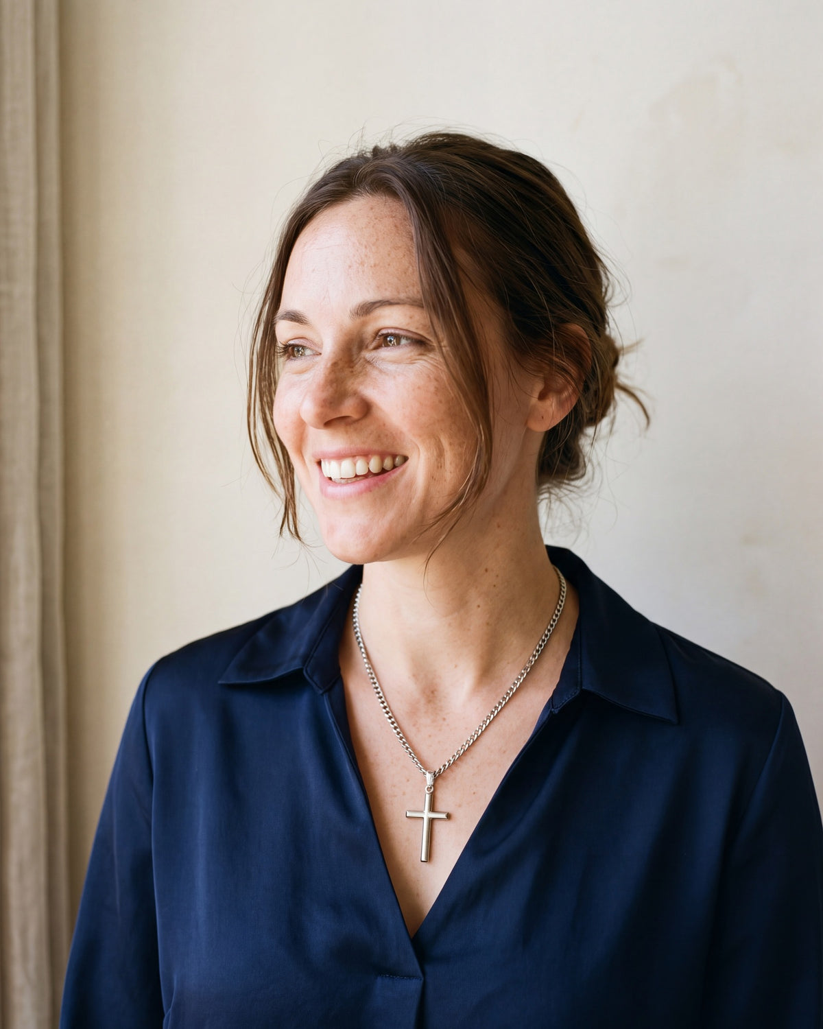 Smiling woman wearing The Devotional Cross [c:silver]
