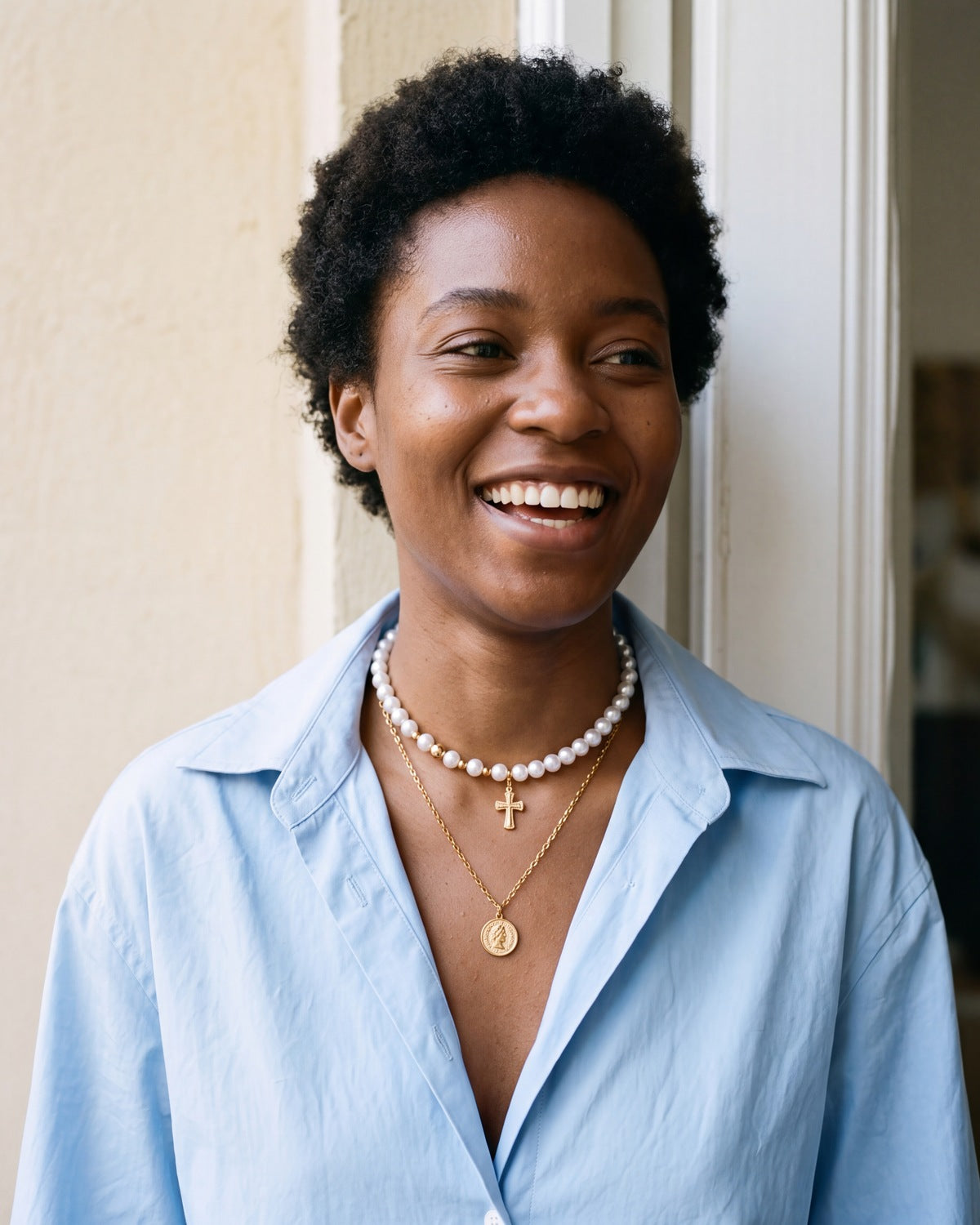 Smiling woman wearing the gold Devout Layers