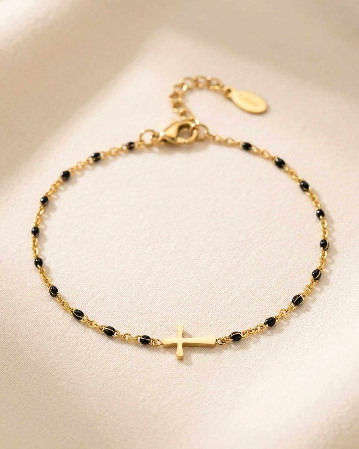 The Devout Path gold cross bracelet with black enamel beads, 3/4 close-up [c:black]