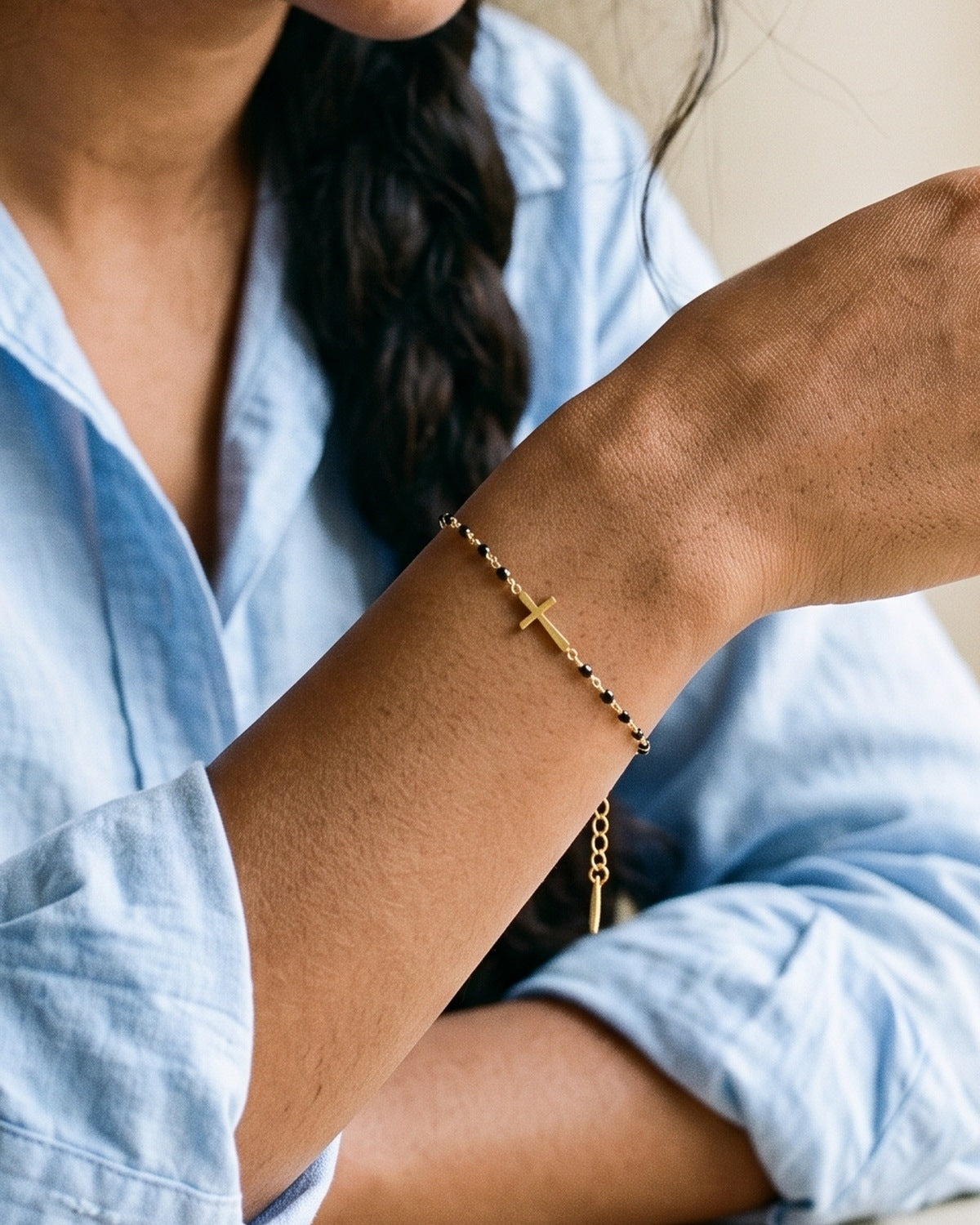 The Devout Path black enamel cross bracelet worn on a woman's wrist, close-up, true to size [c:black]