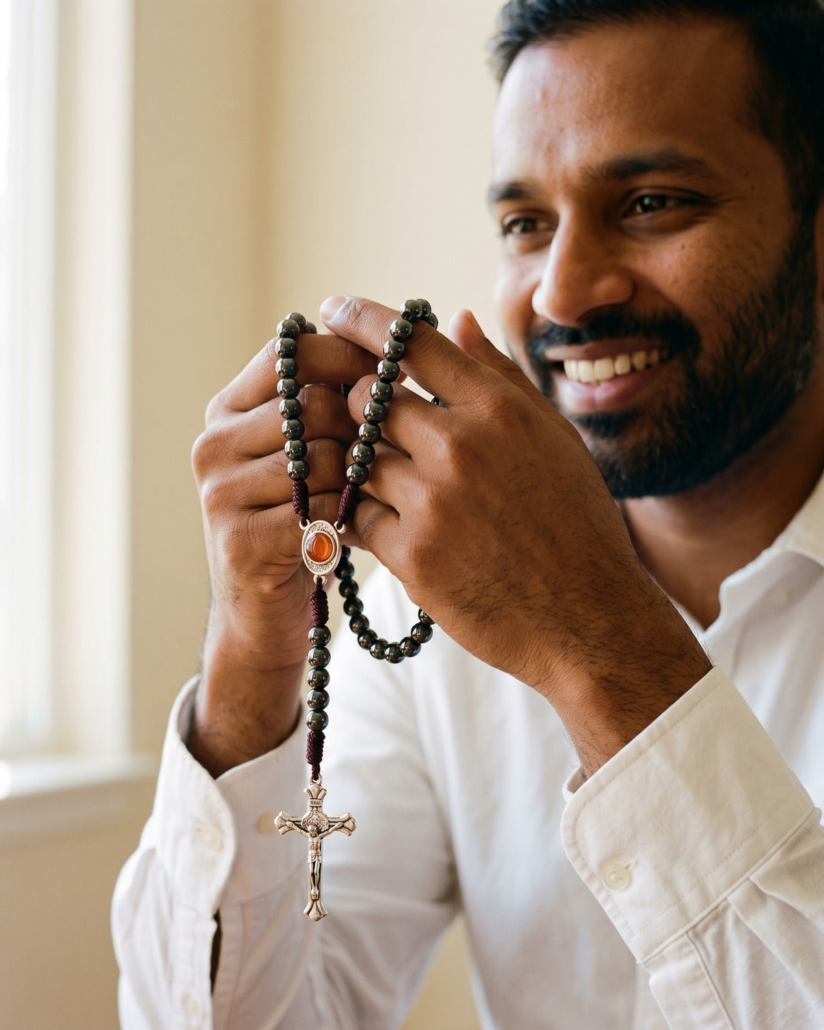 The hematite Devout Rosary held in the hands, true to size [c:hematite]