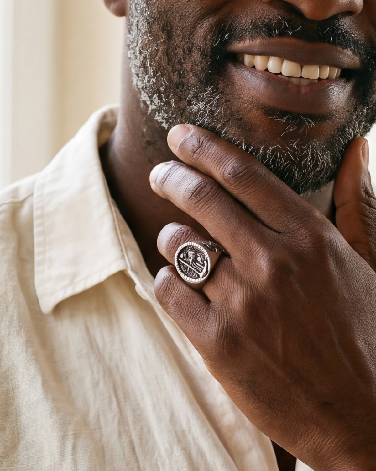 The silver Divine Carrier worn by a man, close-up on the hand, true to size