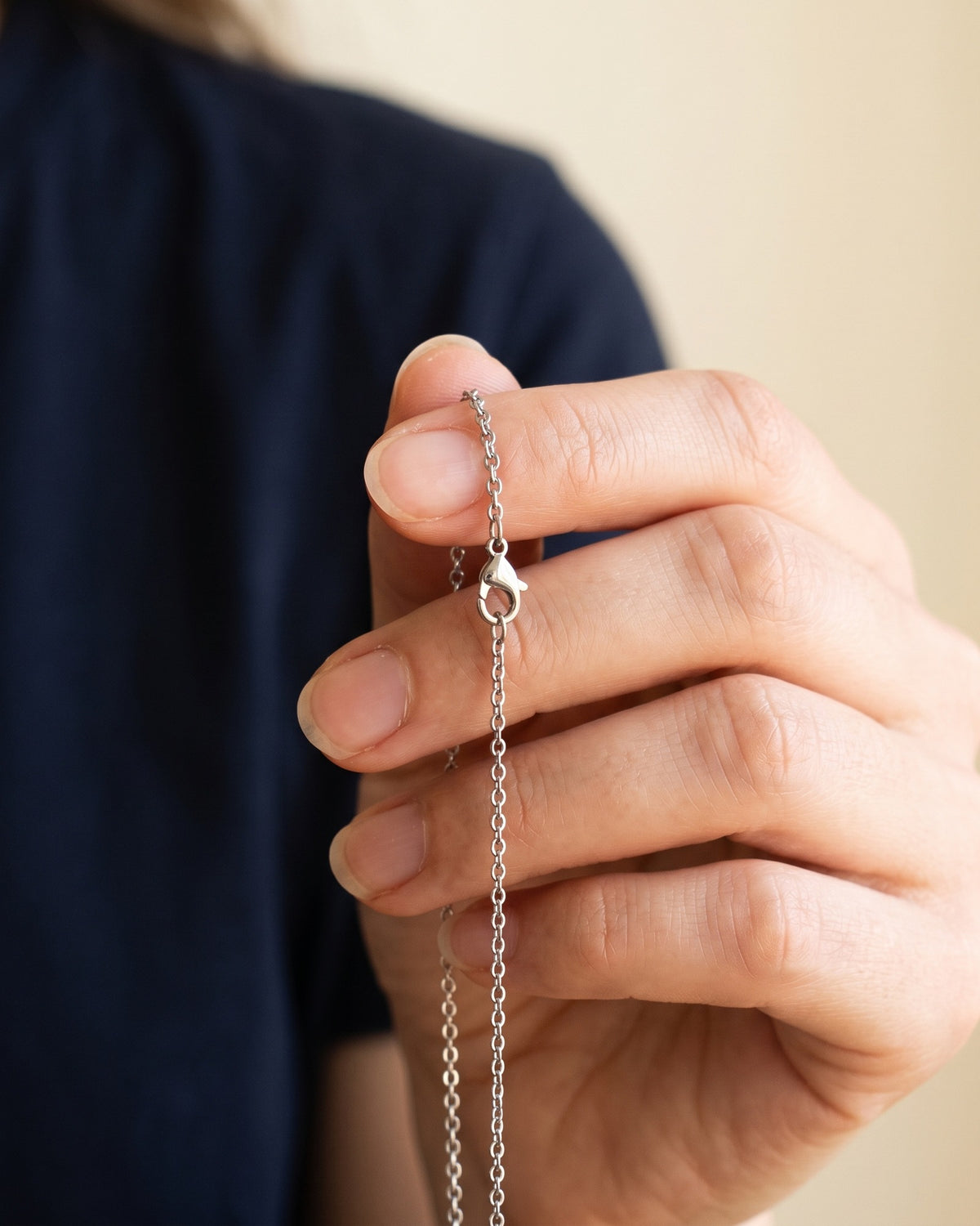 The Enduring Chains held in the hand, true to size