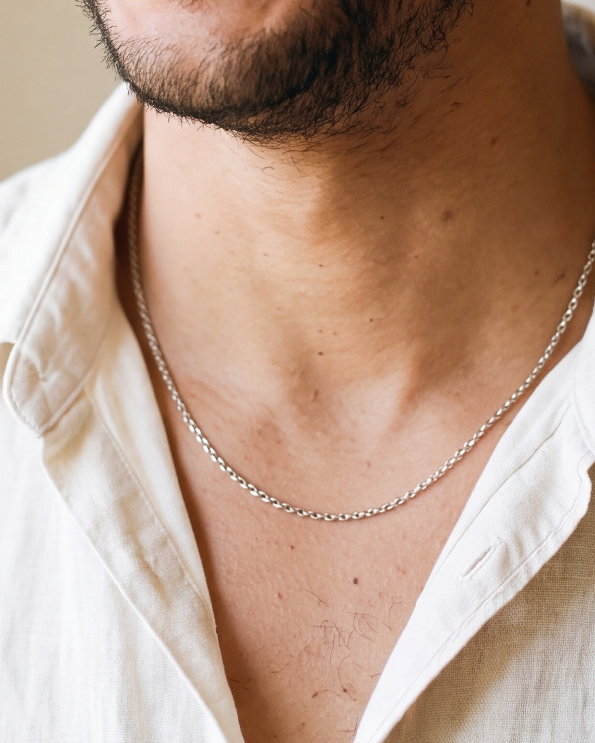 The silver Enduring Chains worn by a man, close-up, true to size