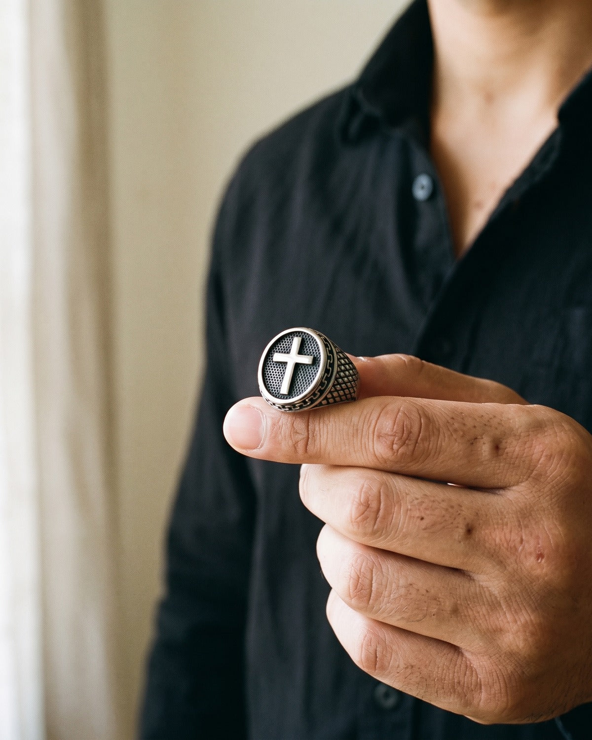 The Enduring Mark held between the fingers, true to size [c:antique-silver]