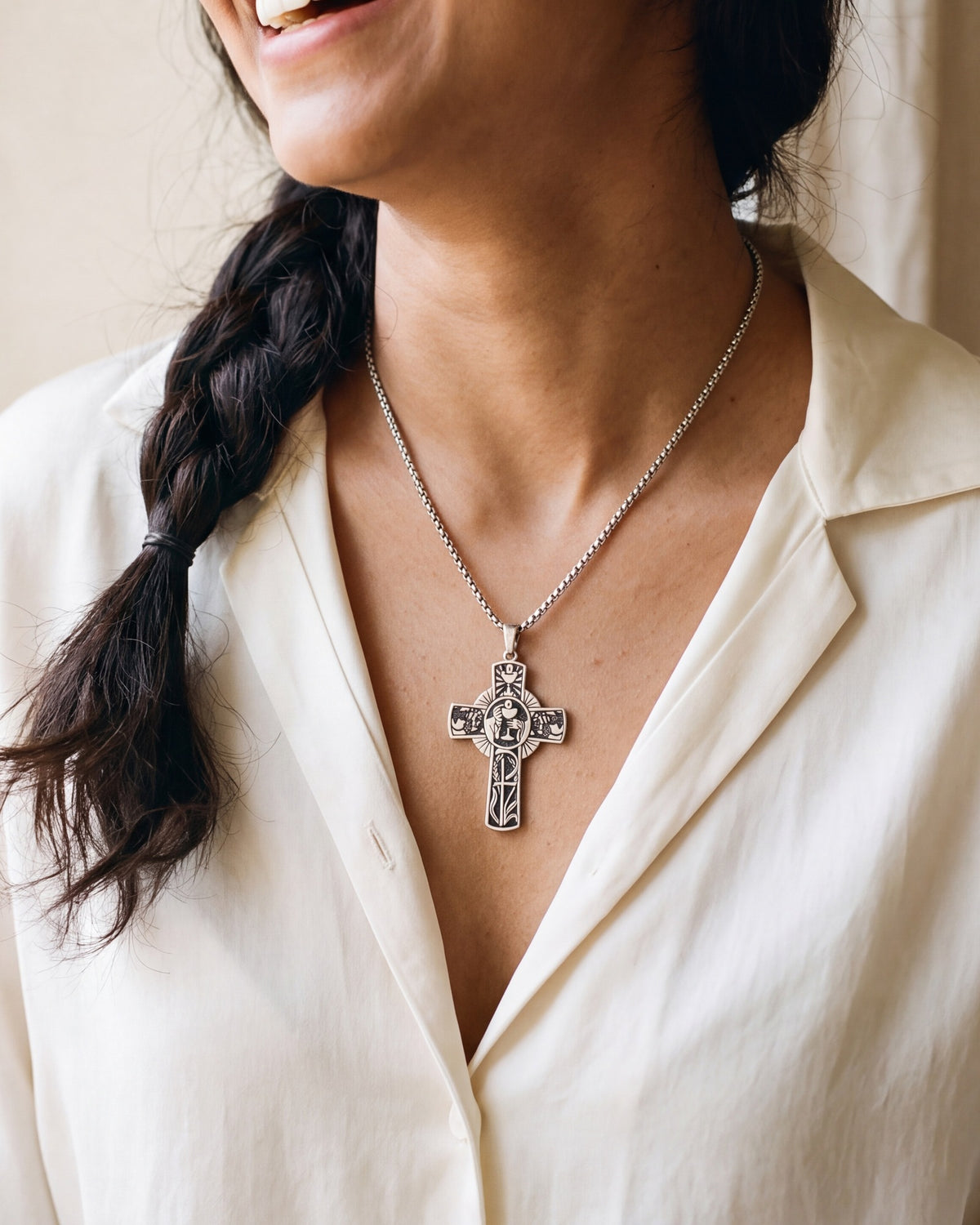 The Eucharistic Cross worn on the chest, close-up, true to size