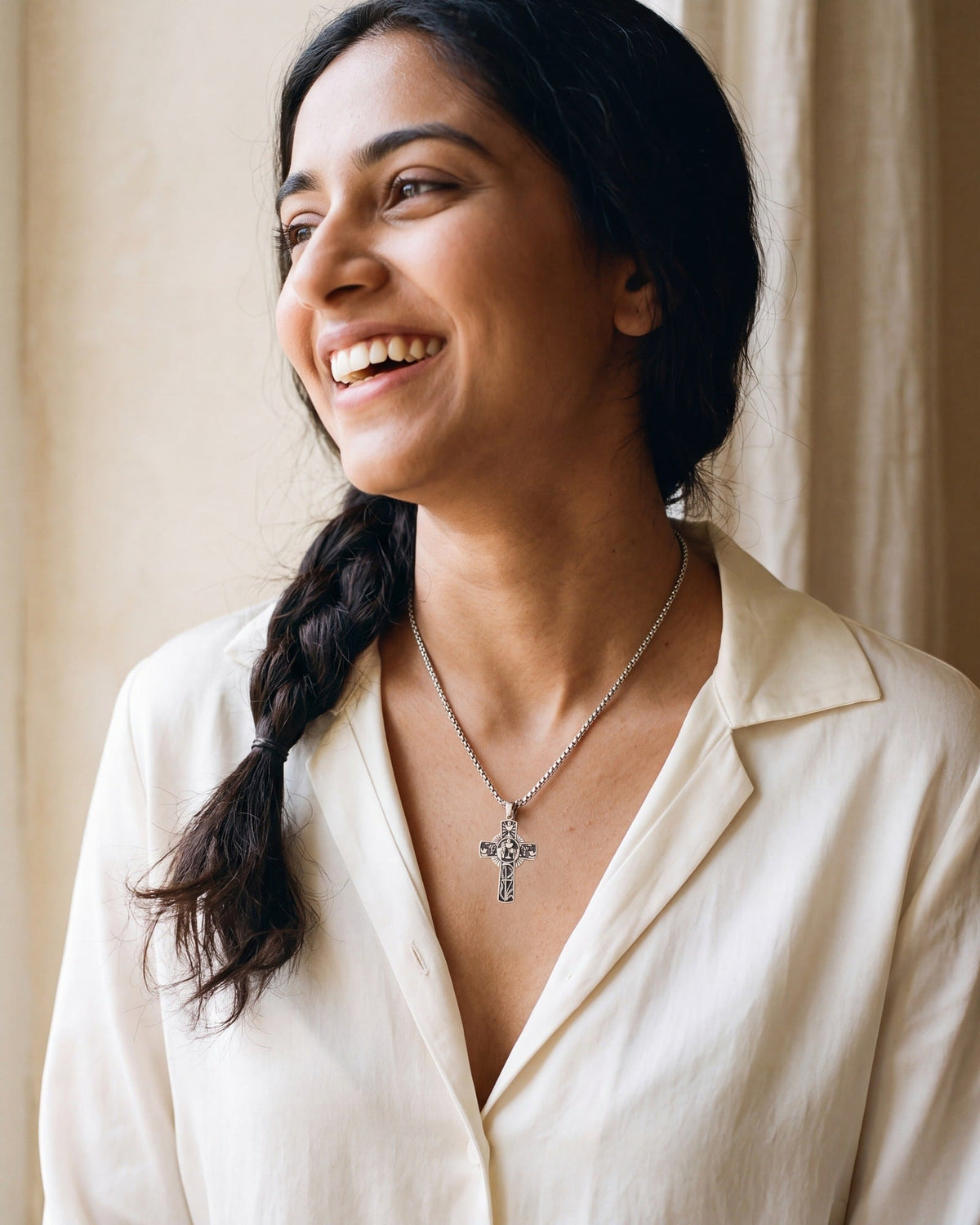 Smiling woman wearing The Eucharistic Cross