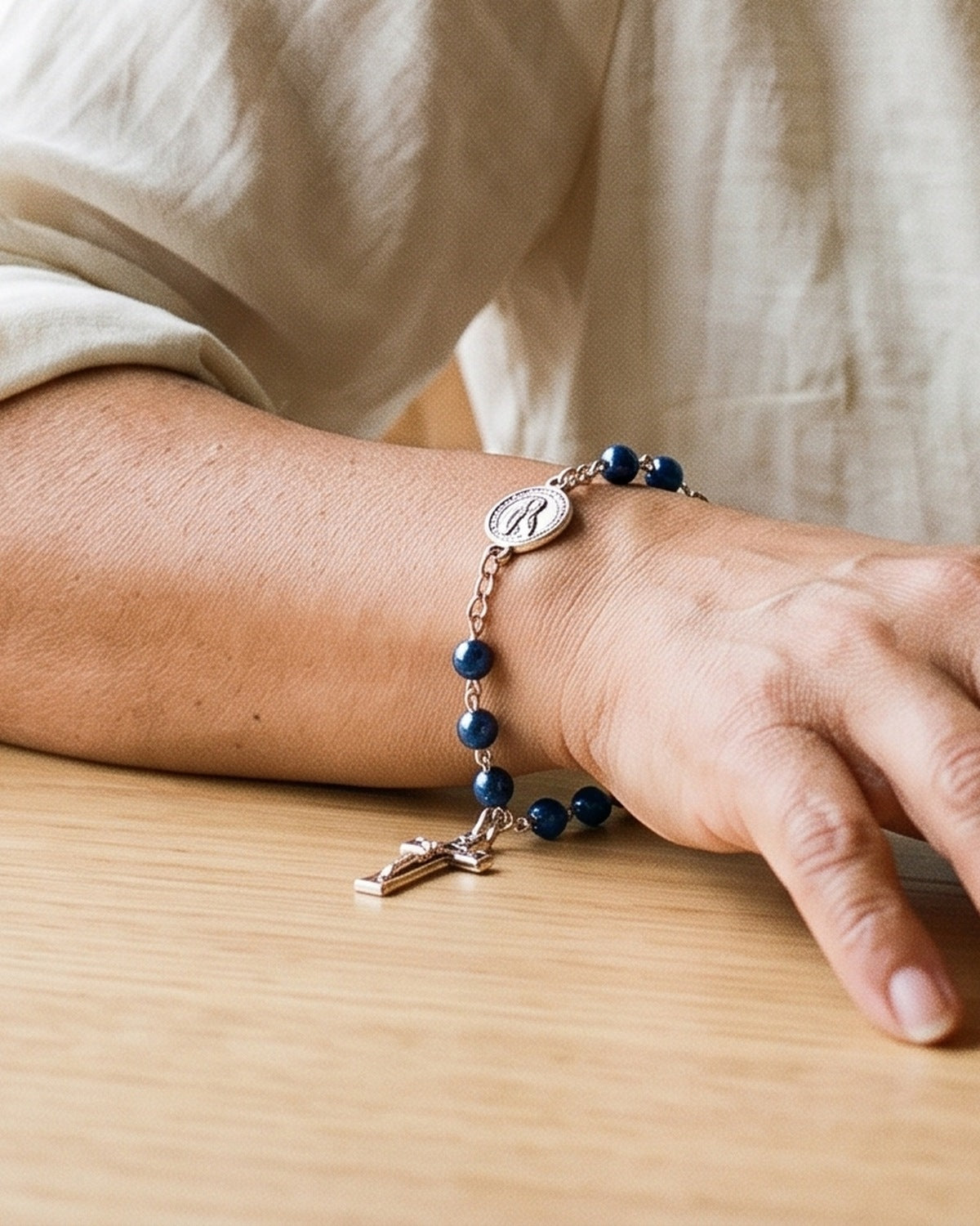 The Fatima Decade on a woman's wrist, close-up, true to size [c:navy-pearl]
