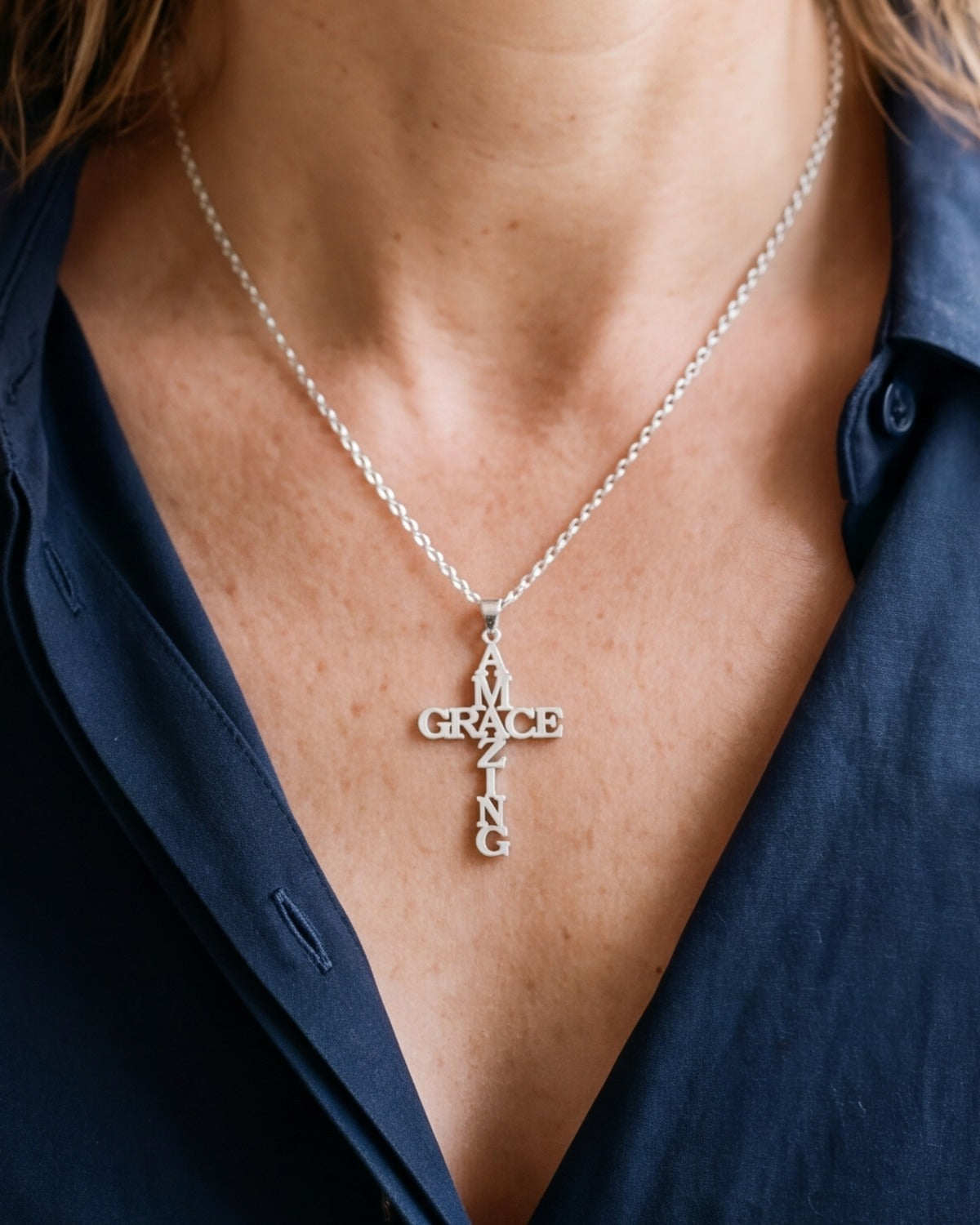 The Graced Cross worn by a woman, close-up, true to size [c:silver]