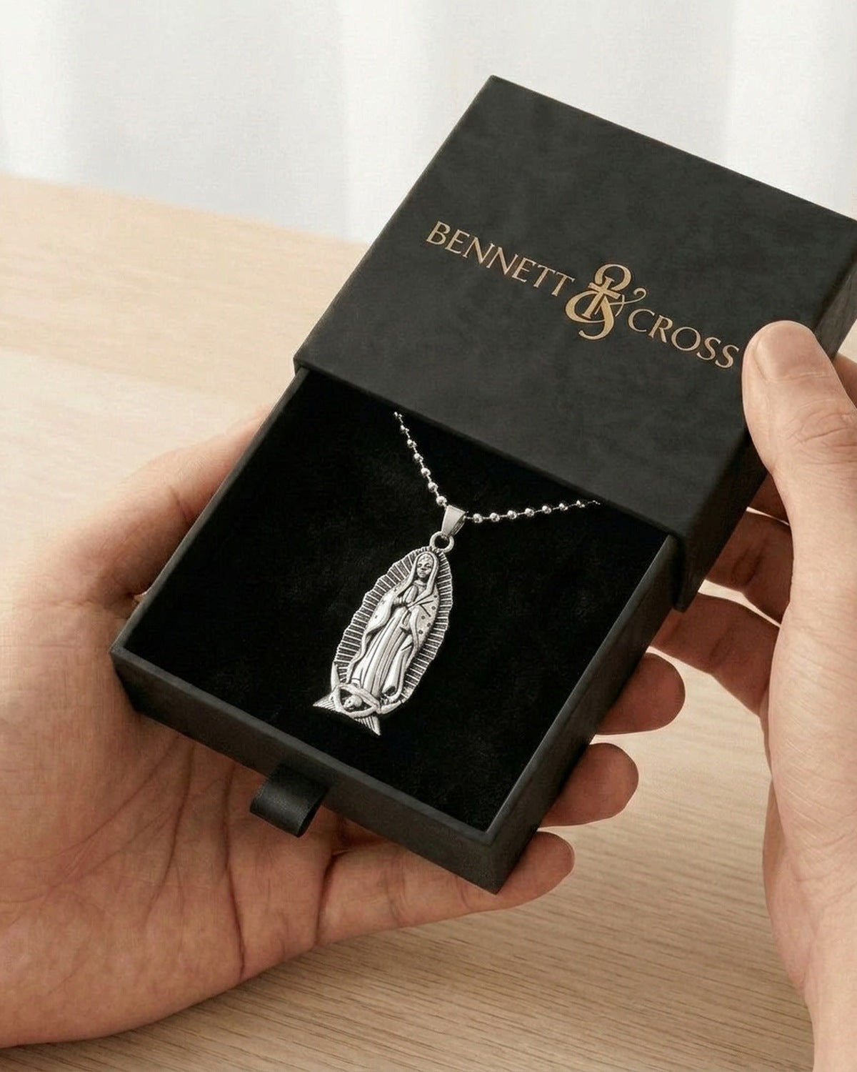 The Guadalupe Relief in its black Bennett & Cross gift box