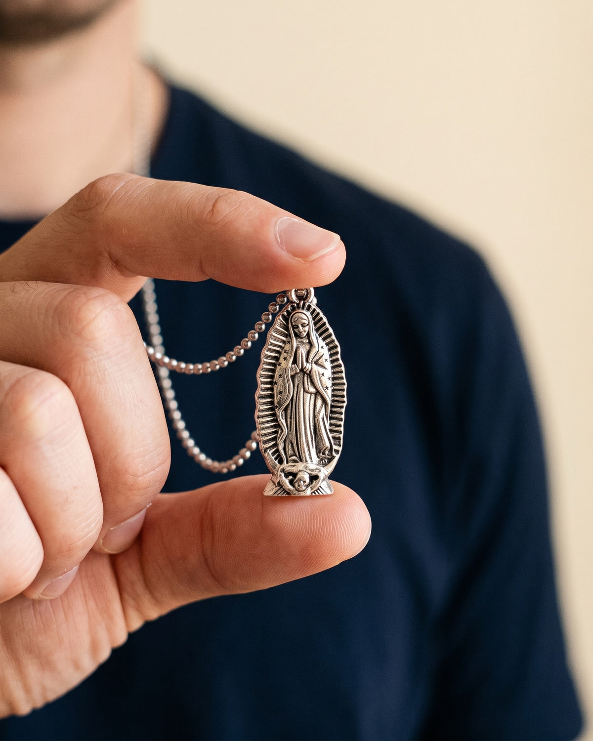 The Guadalupe Relief held in the hand, true to size