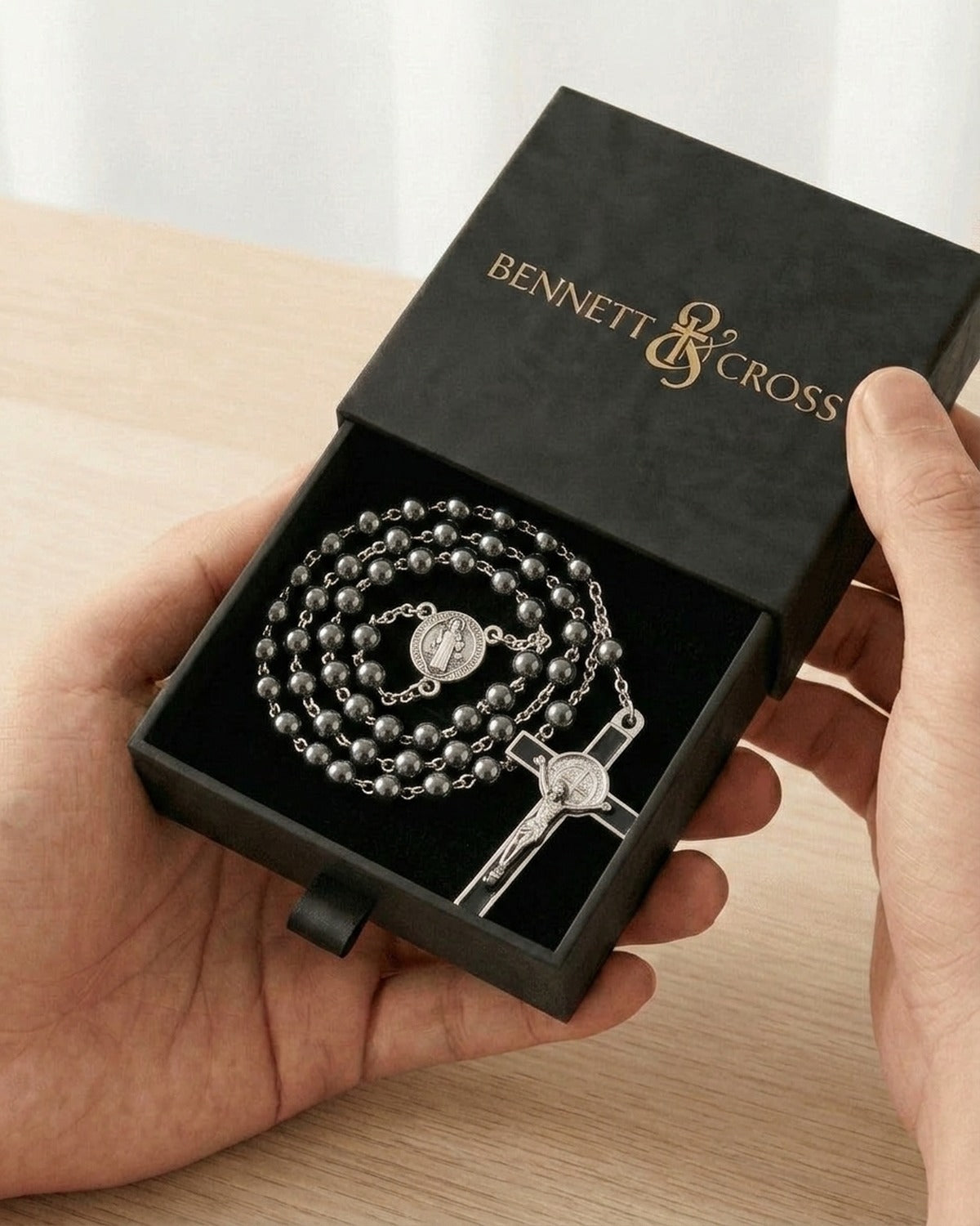 The Hematite Rosary in its black Bennett & Cross gift box