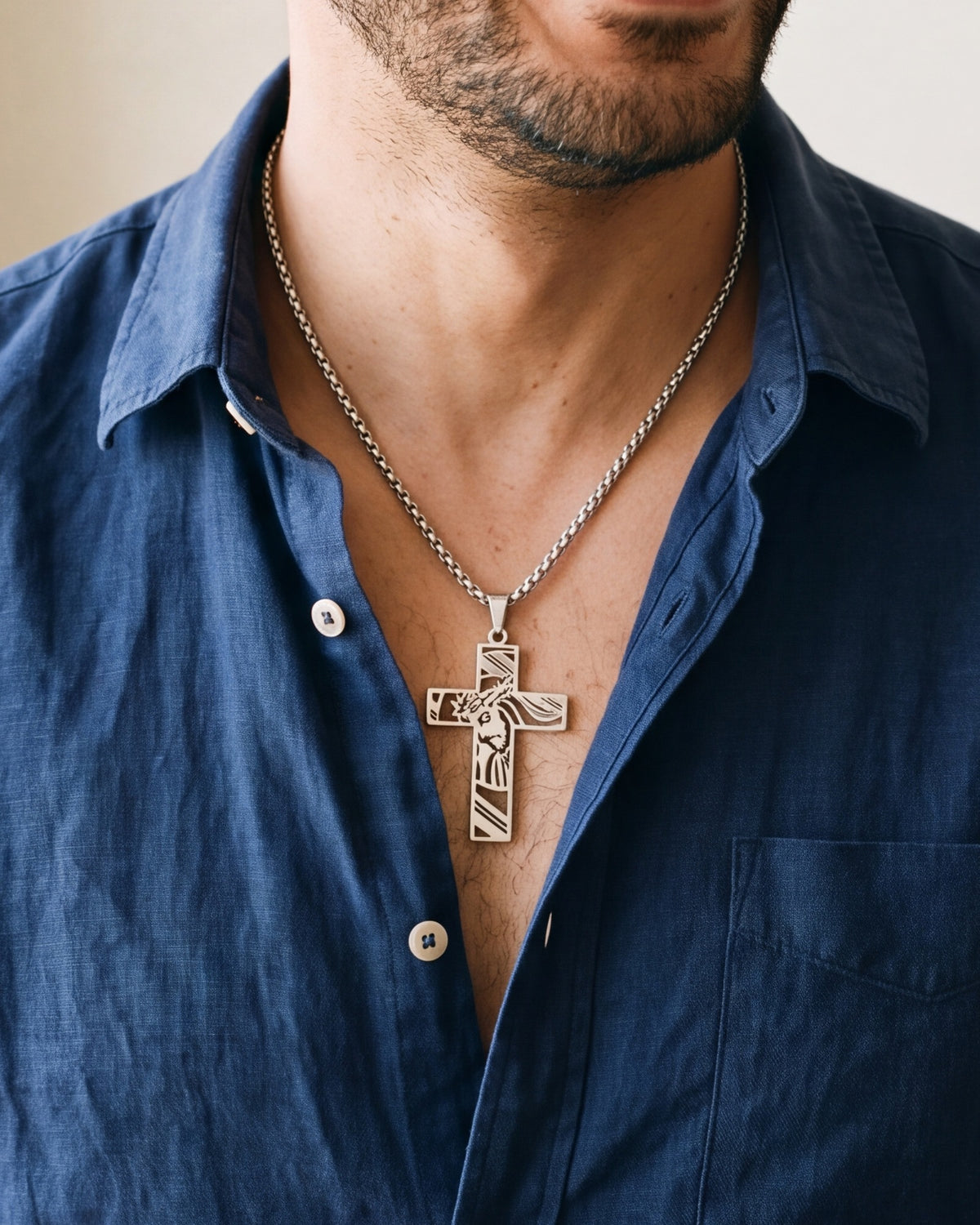 The Holy Visage cross worn by a man, close-up from chin to chest, true to size [c:silver]