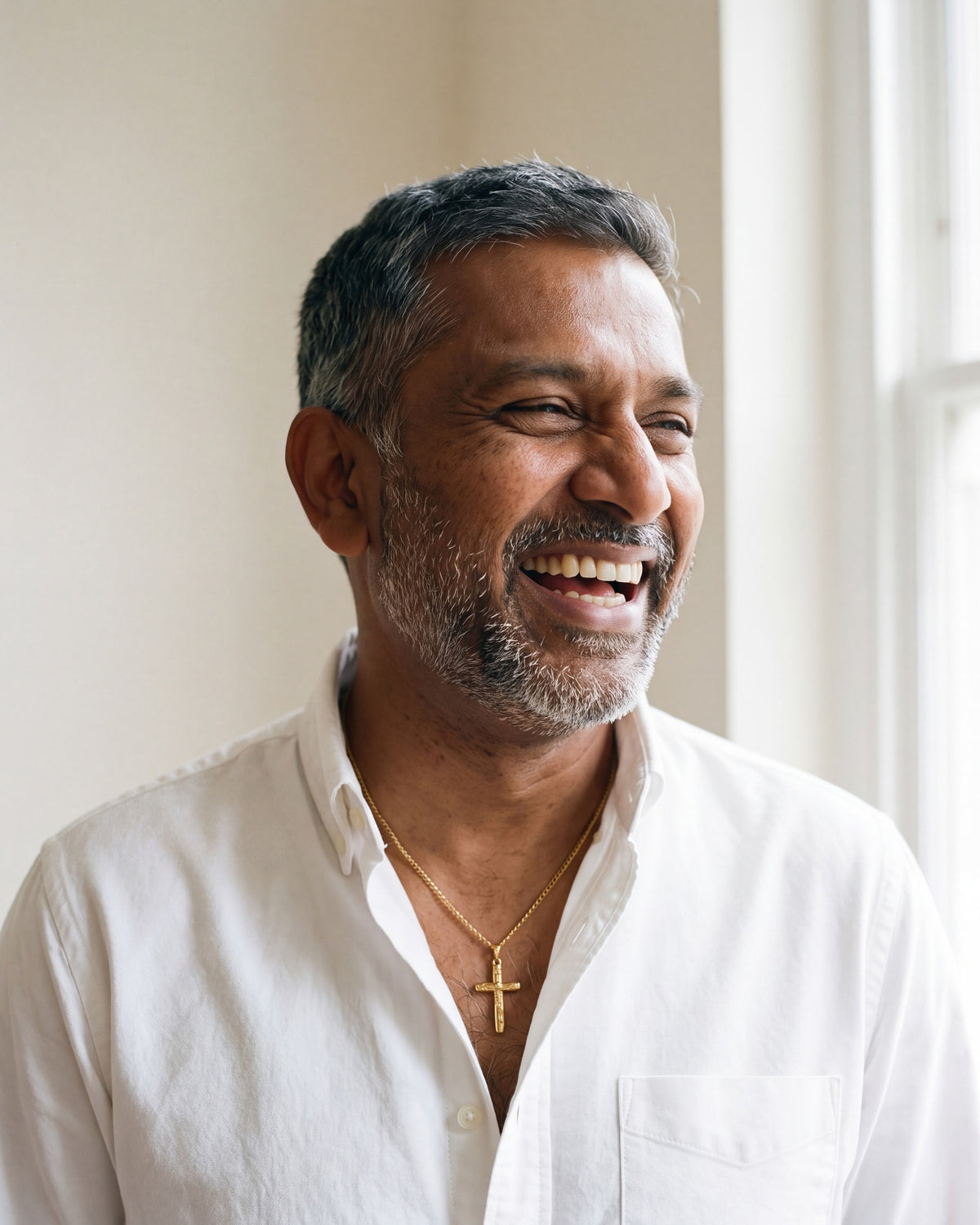 Smiling man wearing The Humble Crucifix [c:gold]