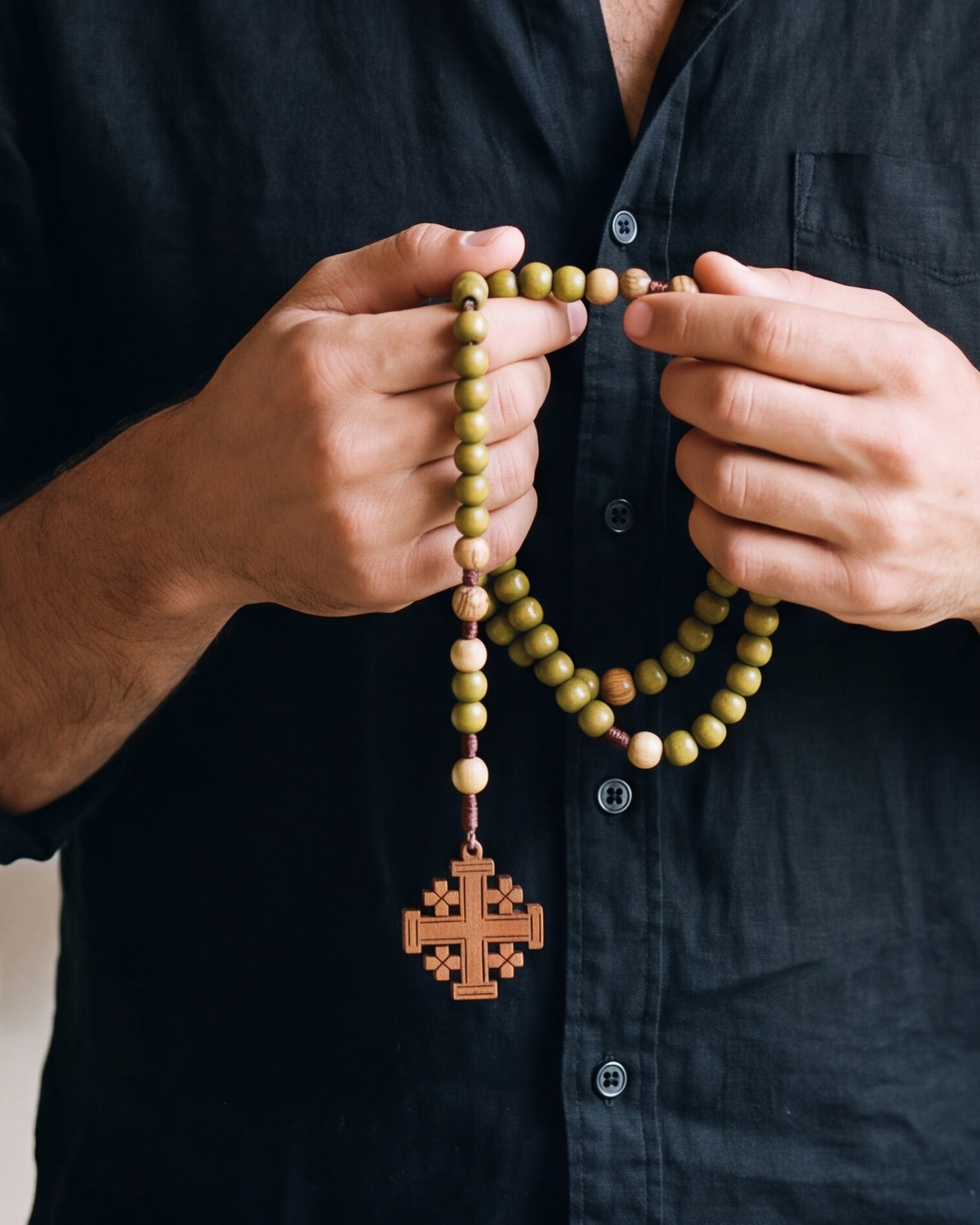 Hands holding The Jerusalem Prayer rosary, close-up, true to size