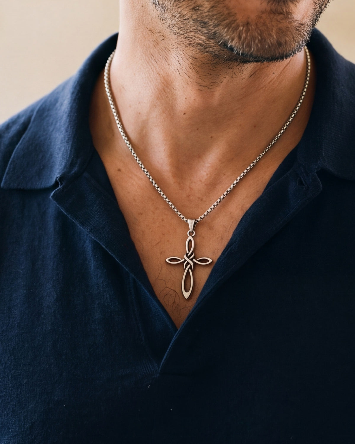 The Knotwork Cross worn by a man, close-up from chin to chest, true to size