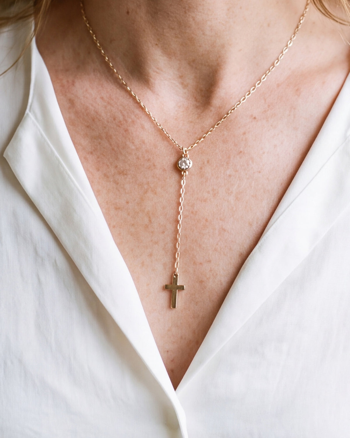 The Lariat Cross worn by a woman, close-up, true to size
