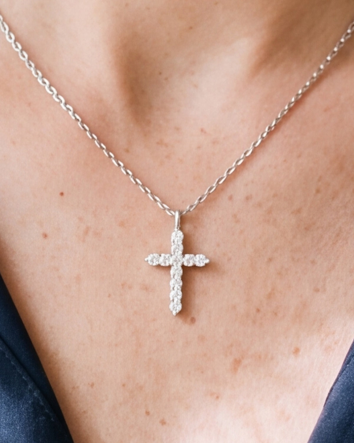 The Luminous Cross worn by a woman, close-up, true to size [c:silver]