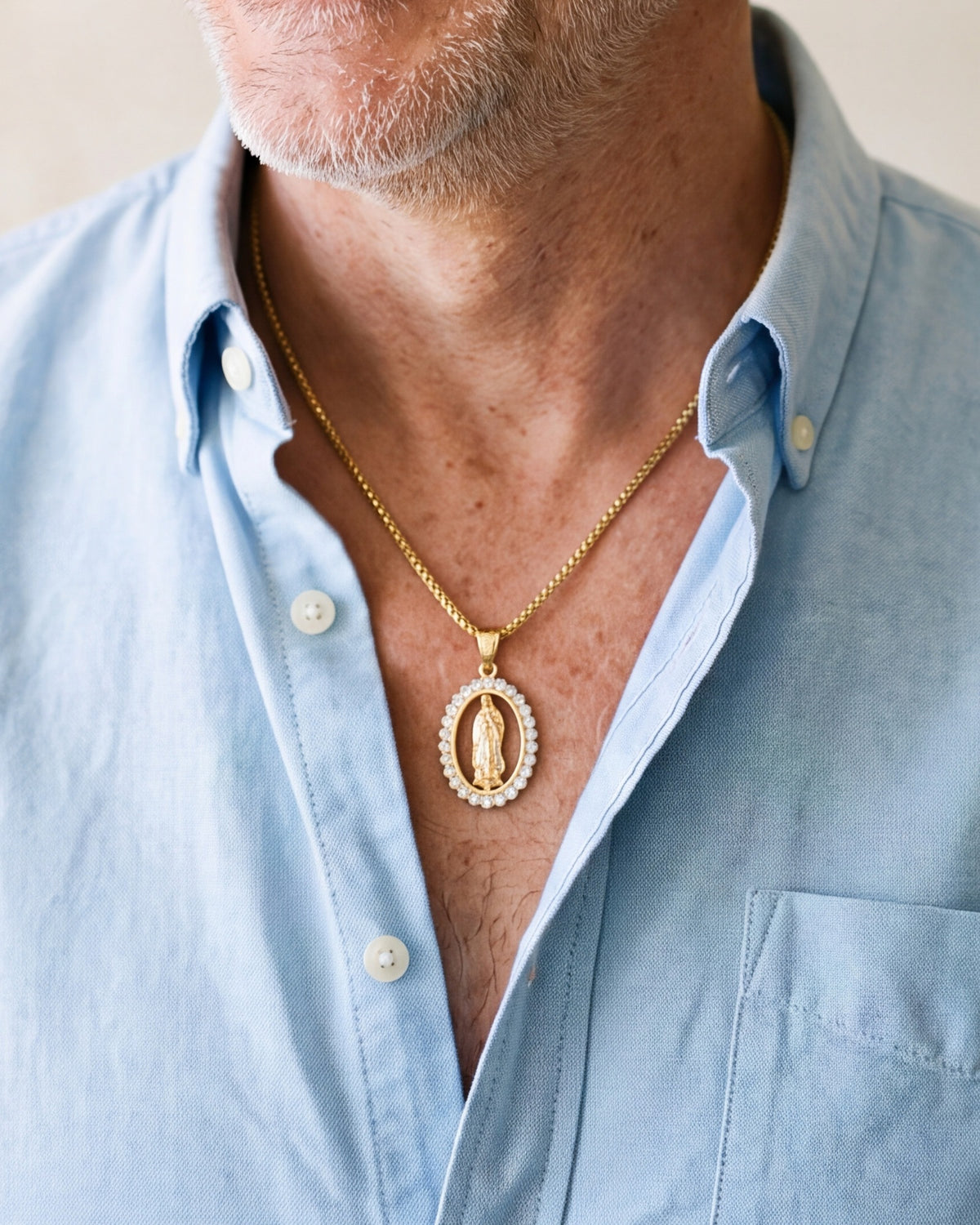 The Marian Radiance worn by a man, close-up from chin to chest, true to size [c:small-25-x-45-mm]