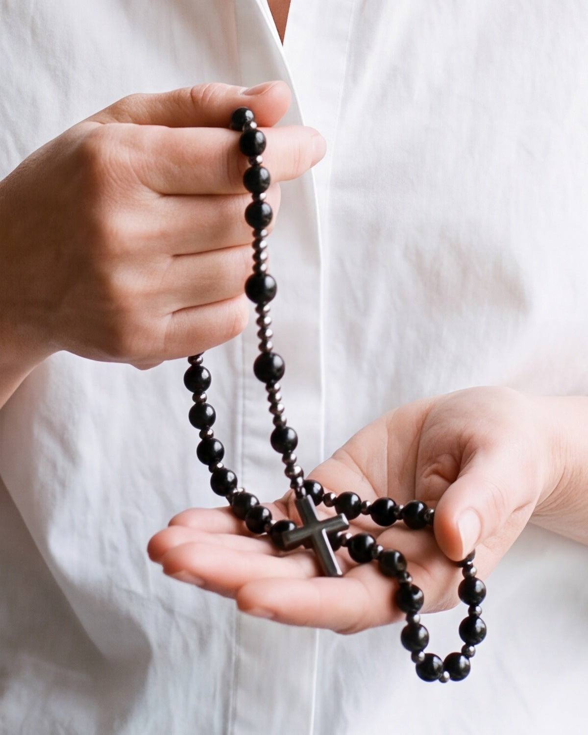 The black Meditative Rosary held in a woman's hands, close-up, true to size [c:black]