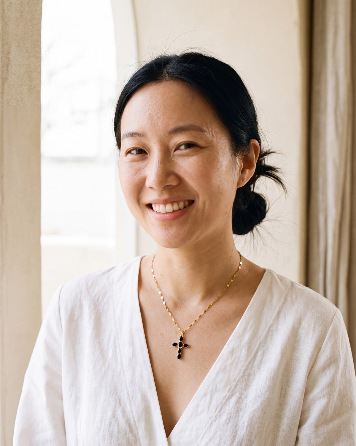 Smiling woman wearing the gold Obsidian Cross [c:gold]