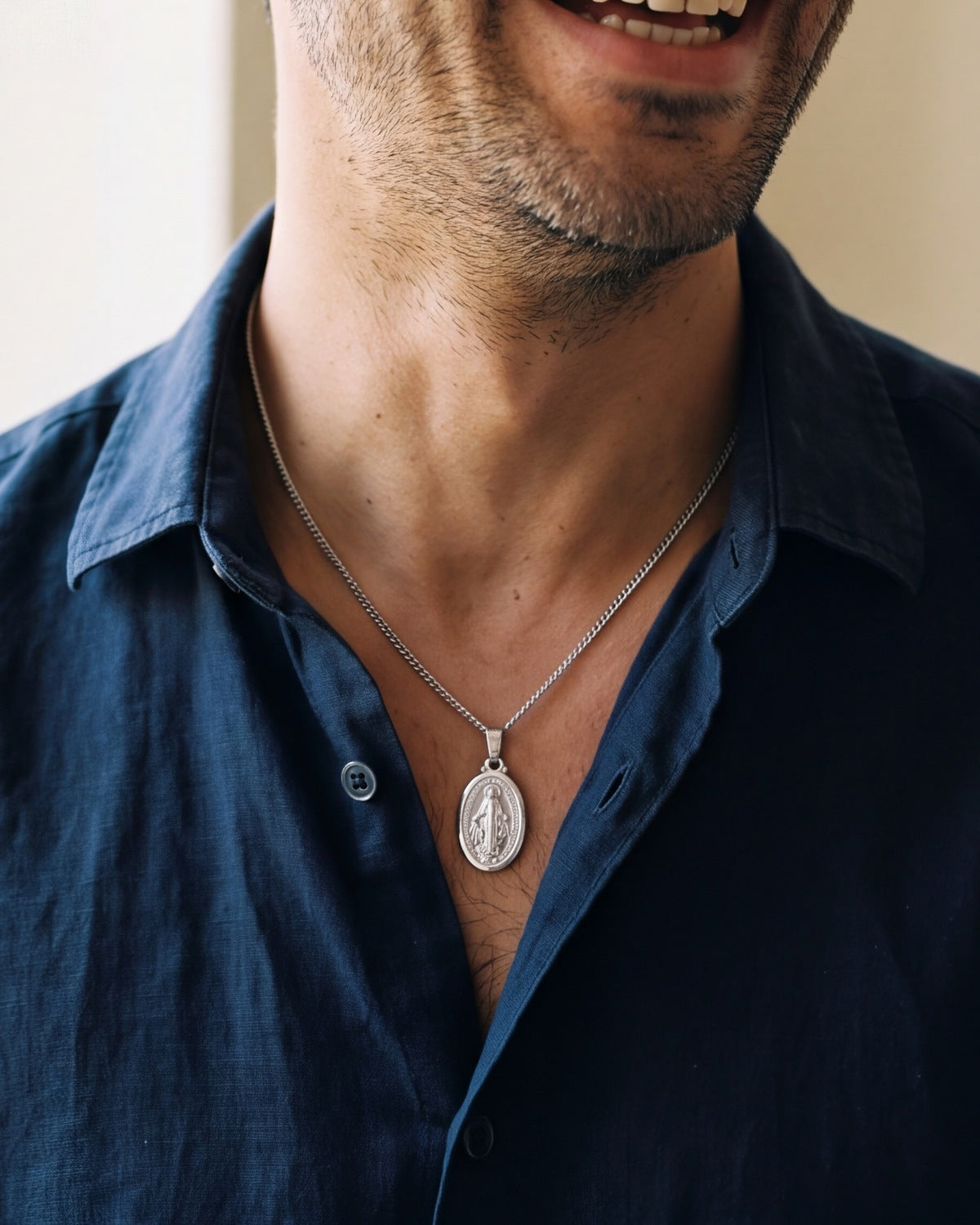 The Petite Miraculous Medal worn on the chest, close-up, true to size [c:silver]