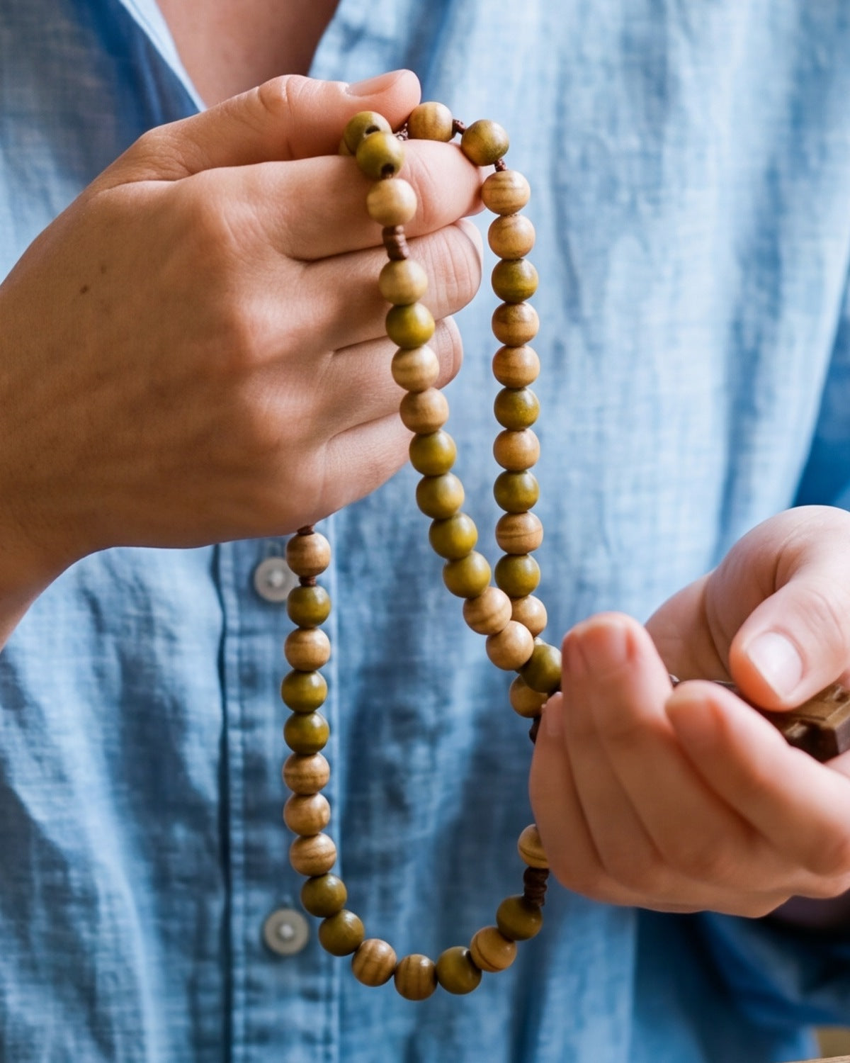 The Pilgrim's Rosary held in a woman's hands, close-up, true to size