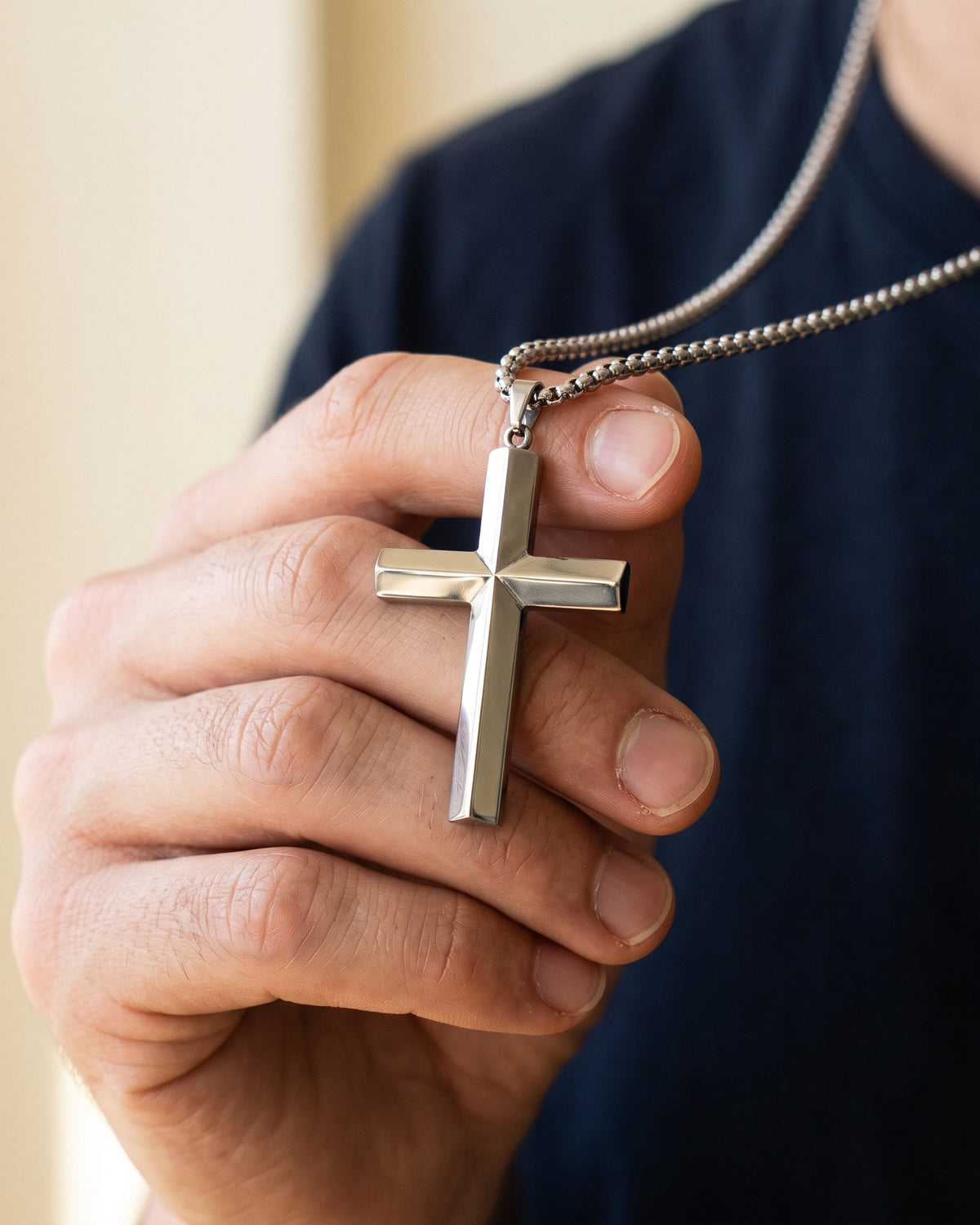 The Polished Cross held in the hand, true to size [c:silver]