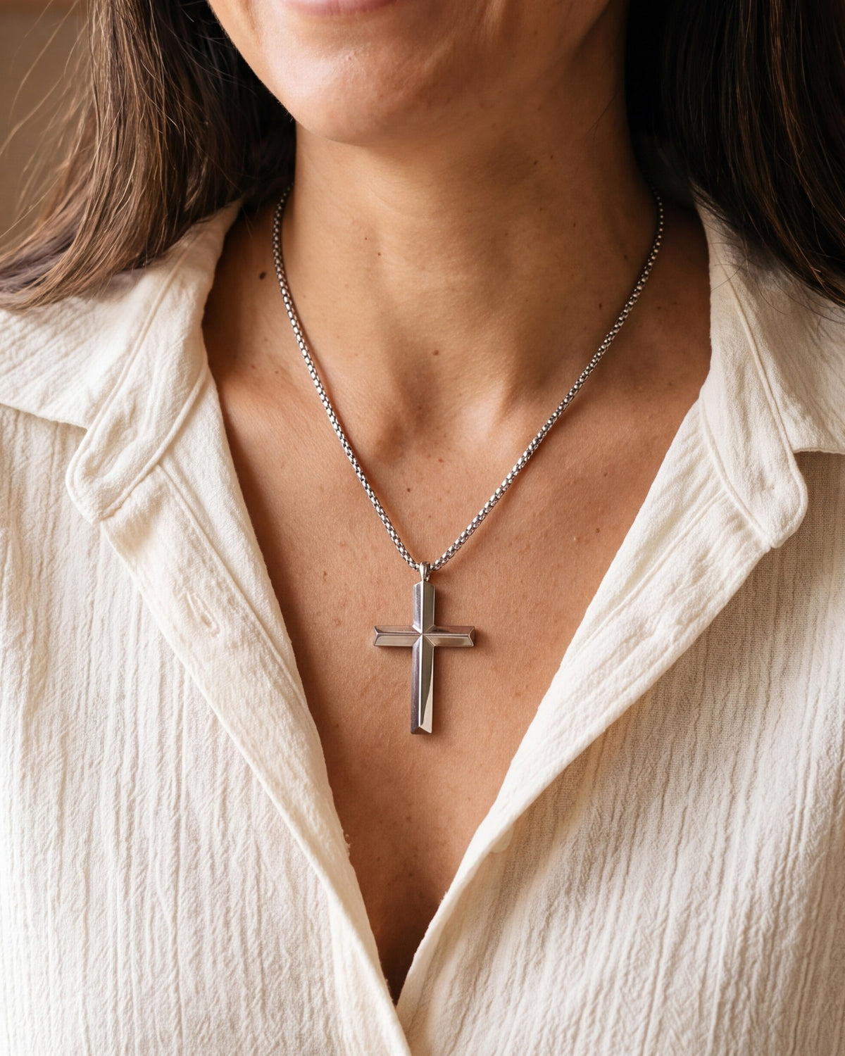 The silver Polished Cross worn by a woman, close-up, true to size [c:silver]
